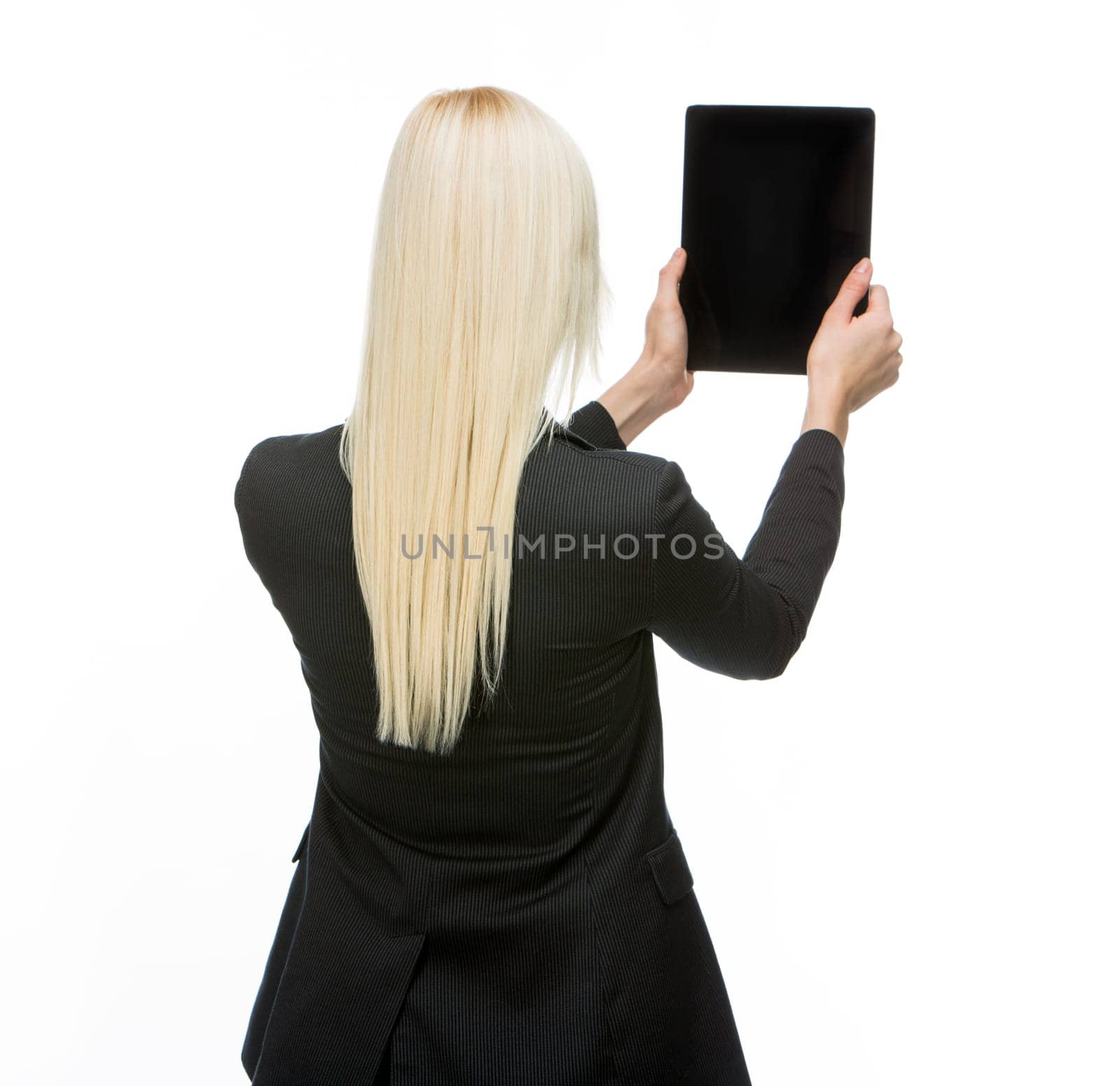 turned back blonde businesswoman holding tablet with black screen