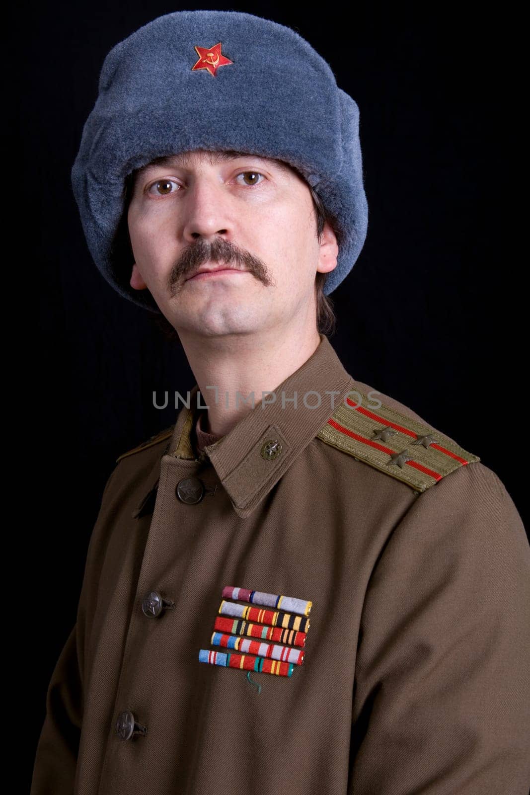 young man dressed as russian military, studio