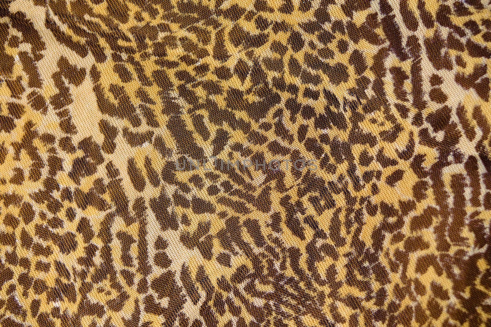 Part of the surface the nylon scarf with animal pattern. macro photography
