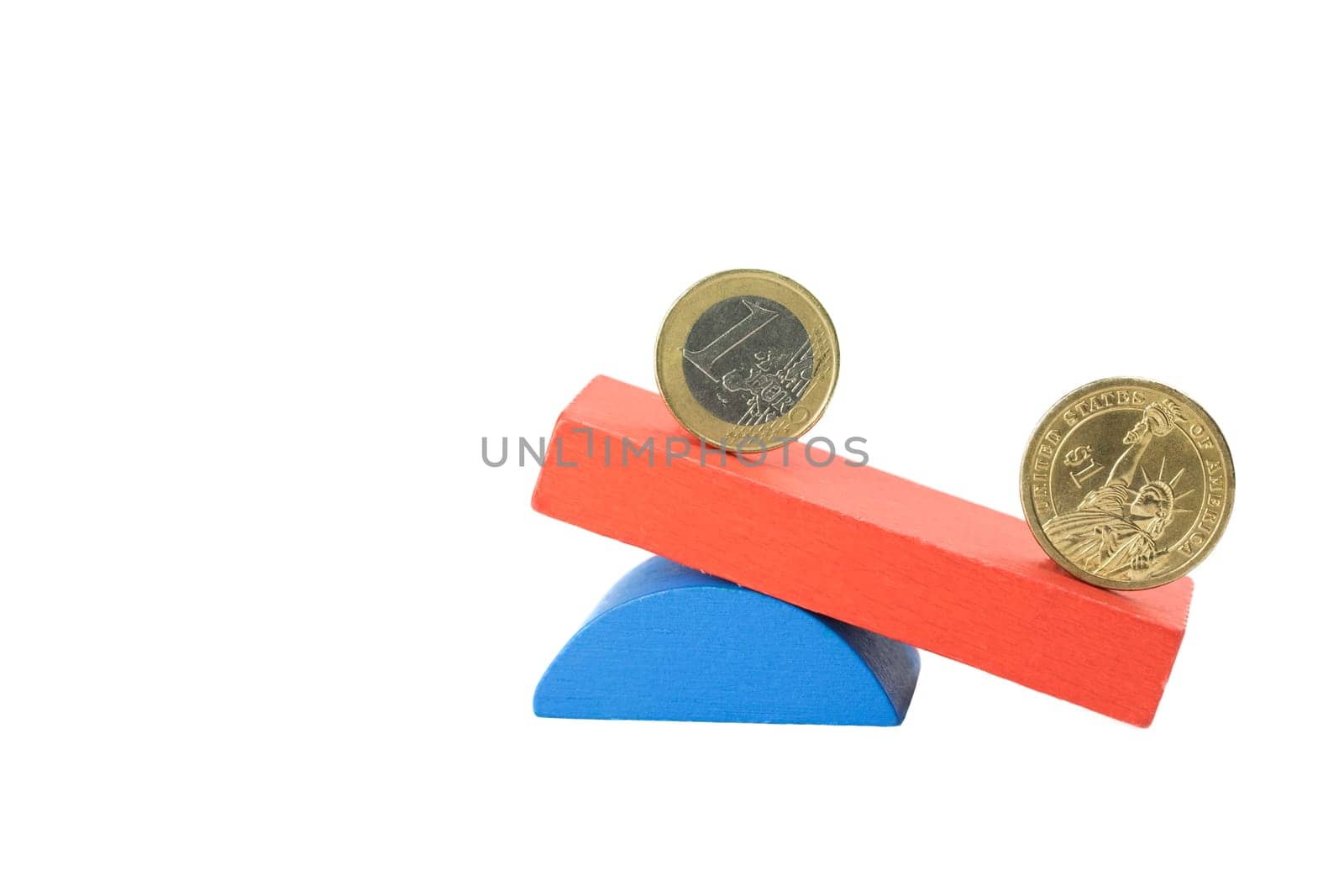 Euro coin and the US one dollar coin stand on the swing from wooden color blocks. Swing is on the side with the US dollar below.