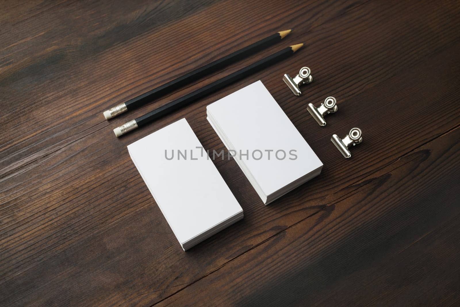 Blank business cards and pencils on wood table background. Branding ID template. Stationery mock up.