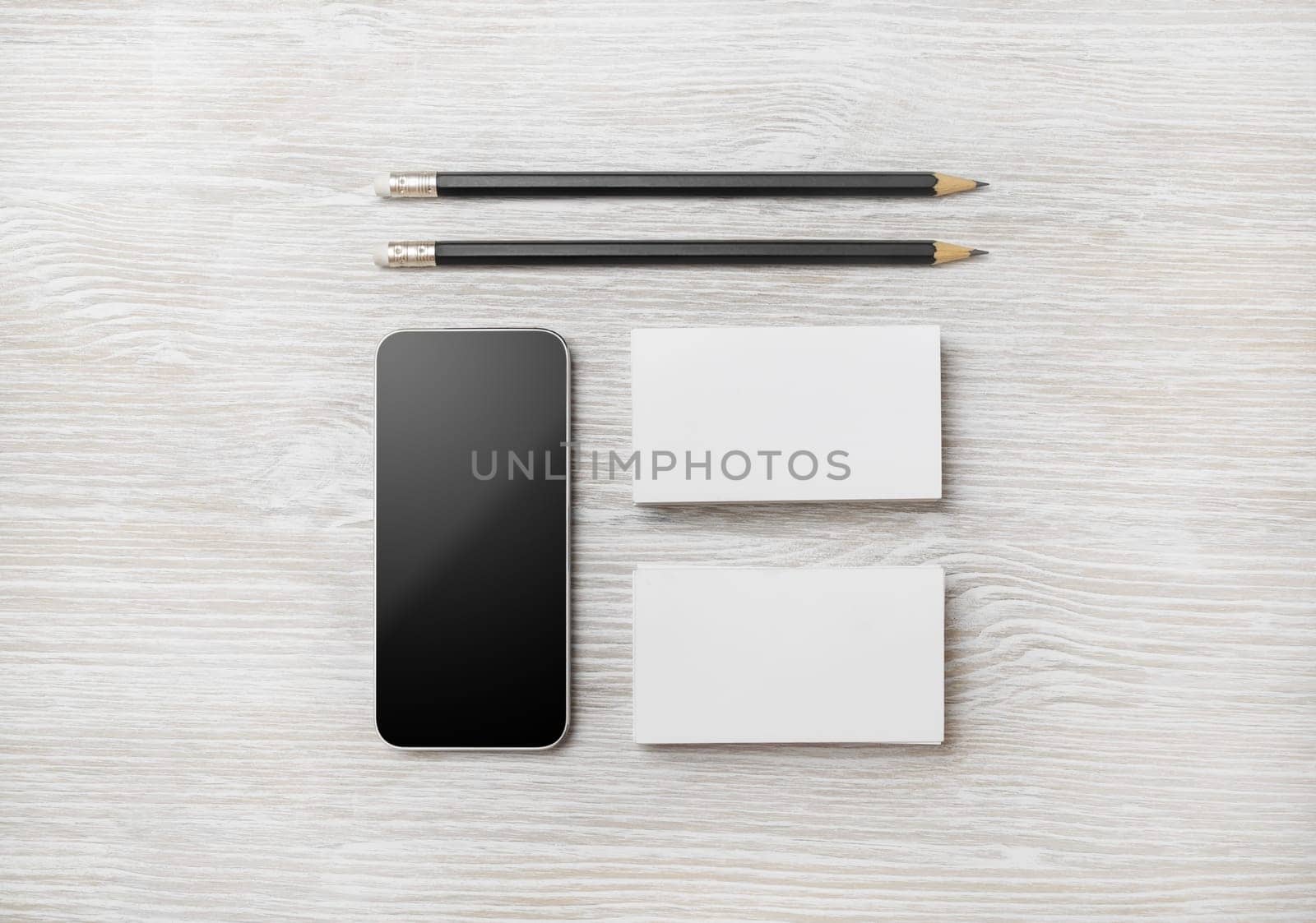 Branding stationery template. Blank business cards and pencil on light wood table background. Flat lay.