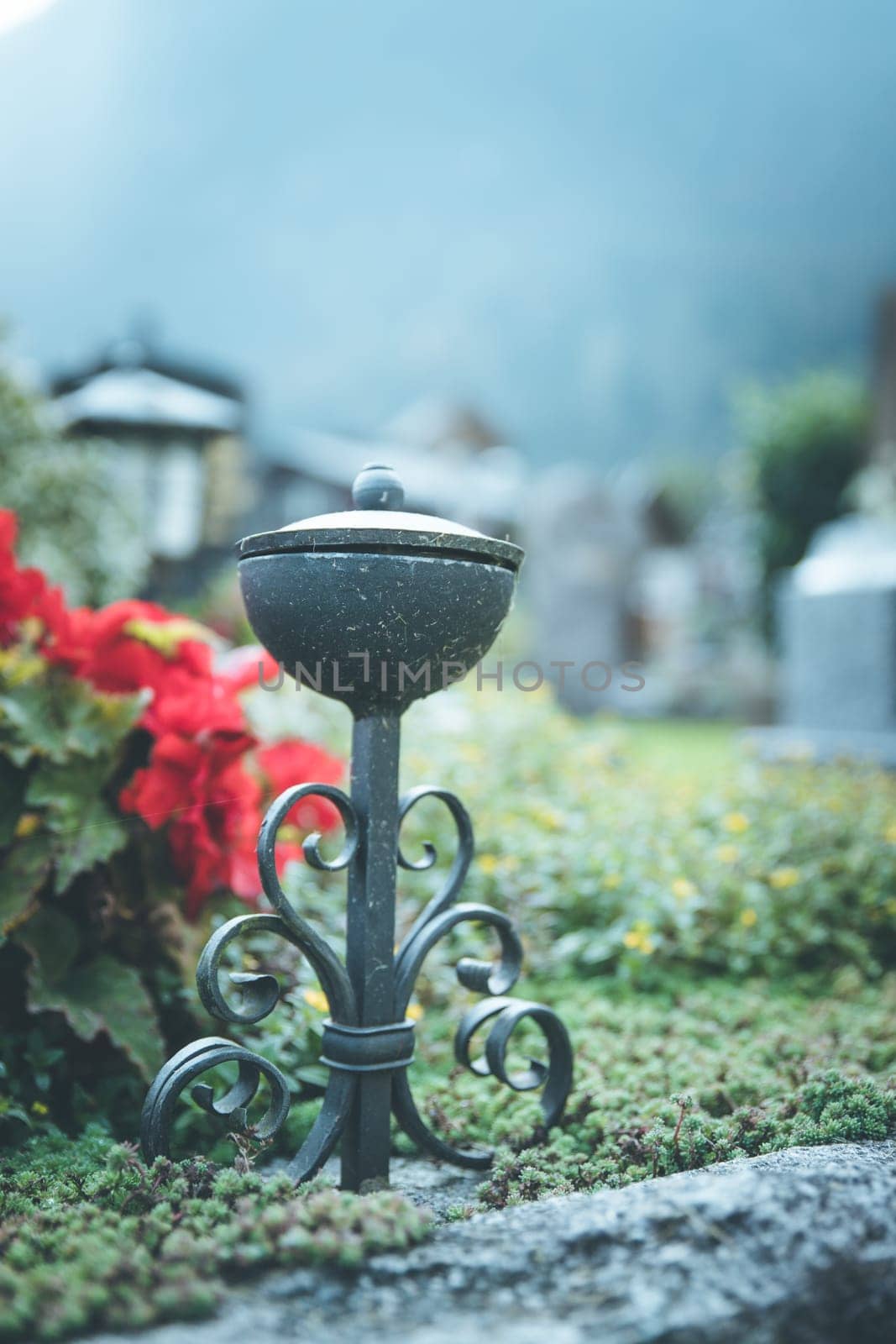 Iron holy water bowl on a cemetery