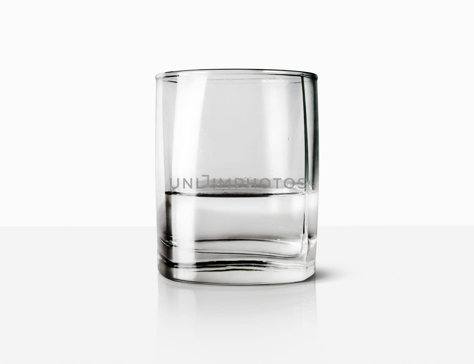 Glass with water on a light background.
