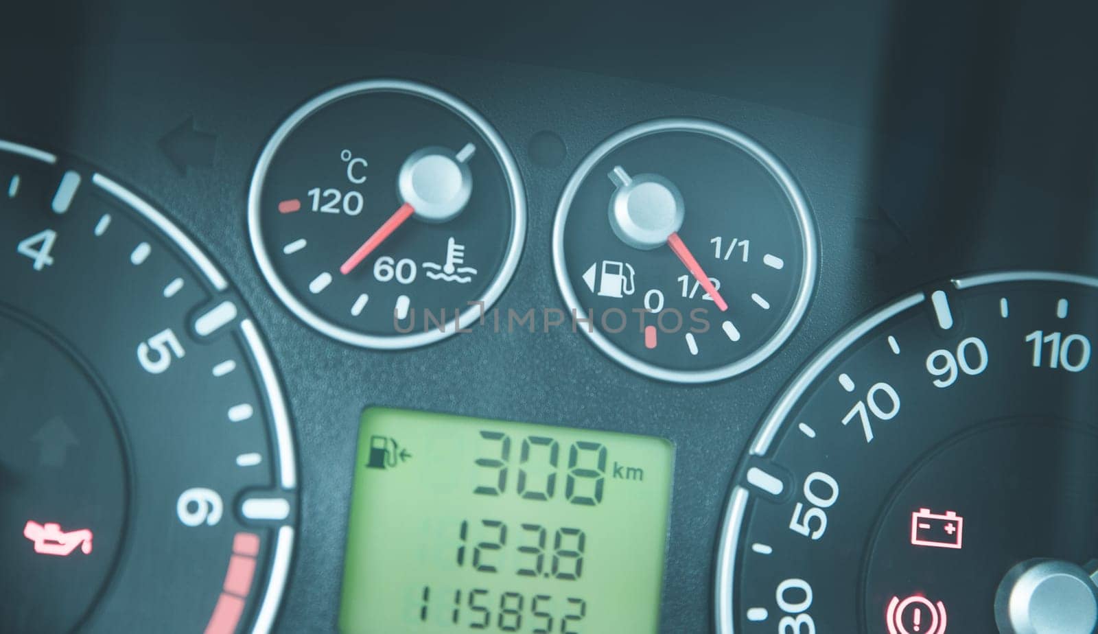 Close up picture of car dashboard with instruments and tachometer