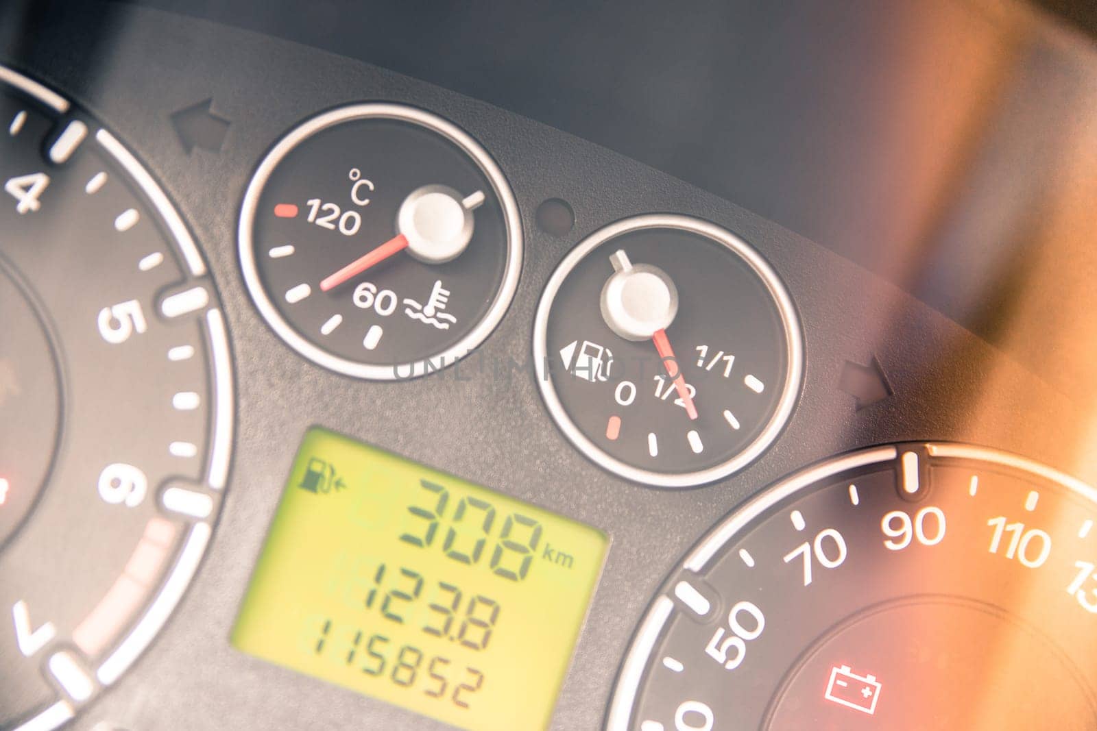 Close up picture of car dashboard with instruments and tachometer