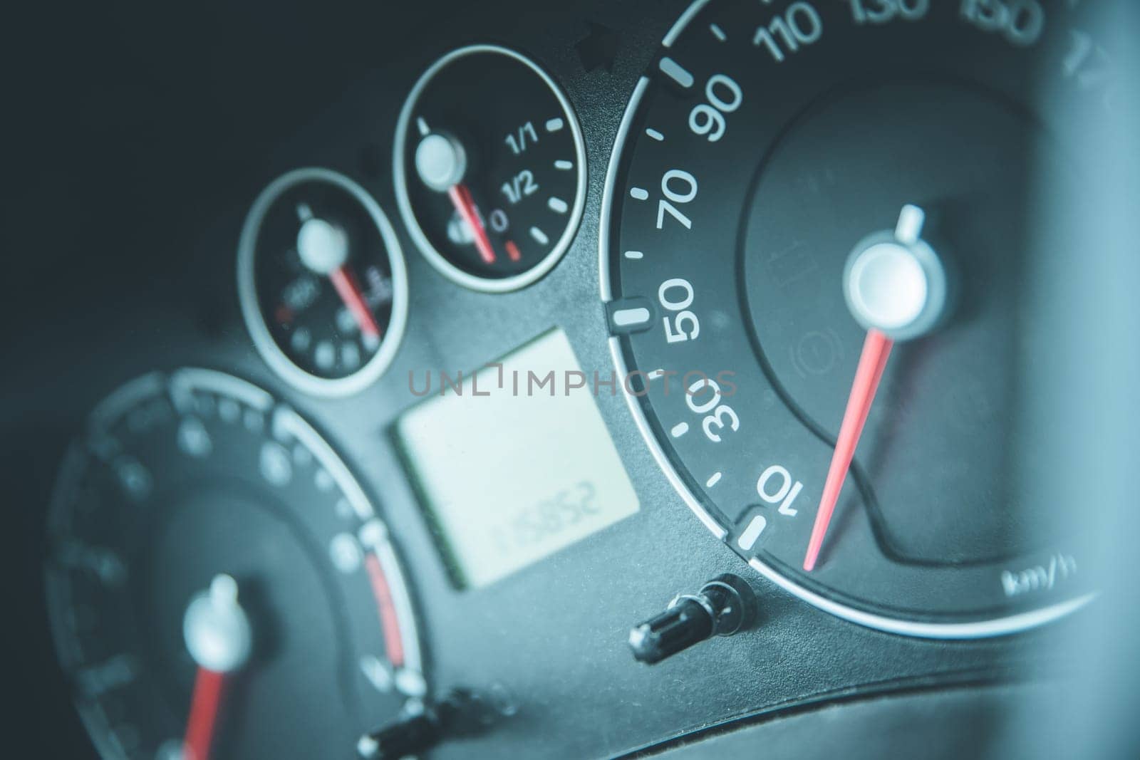 Close up picture of car dashboard with instruments and tachometer