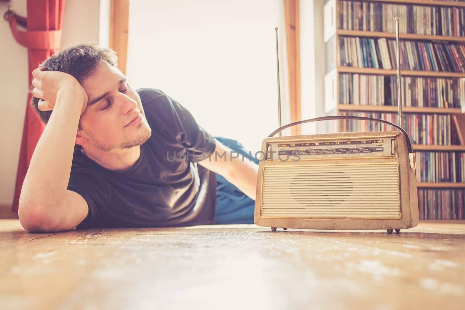 Young man listeining to an retro radio