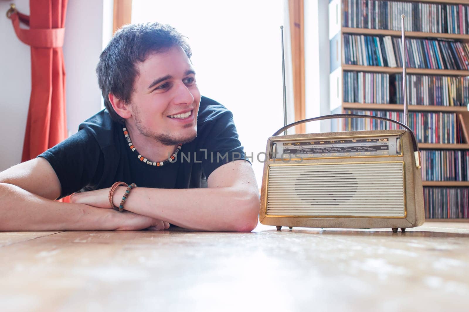 Young man listeining to an retro radio