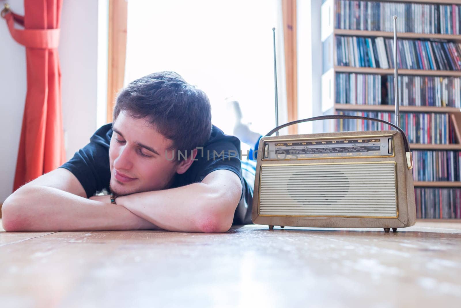 Young man listeining to an retro radio