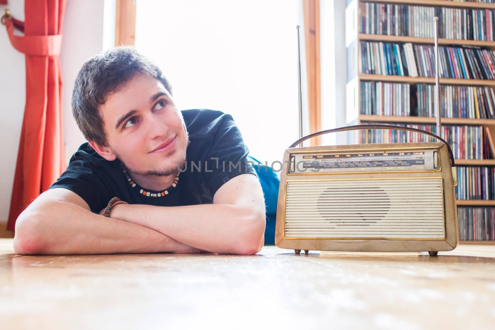 Young man listeining to an retro radio