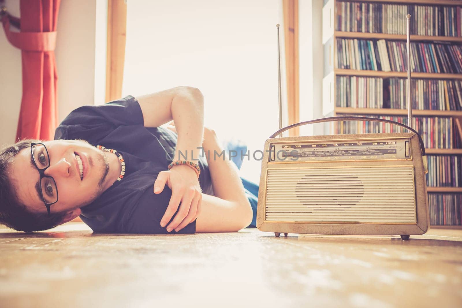 Young man listeining to an retro radio