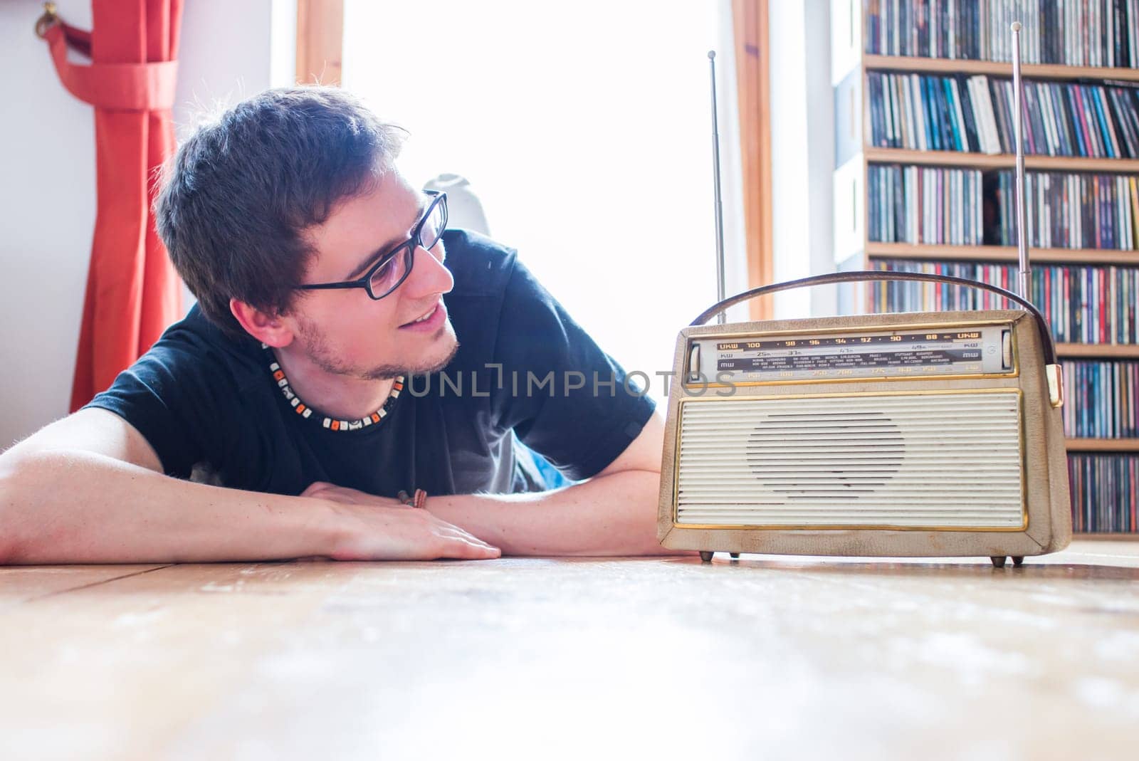 Young man listeining to an retro radio