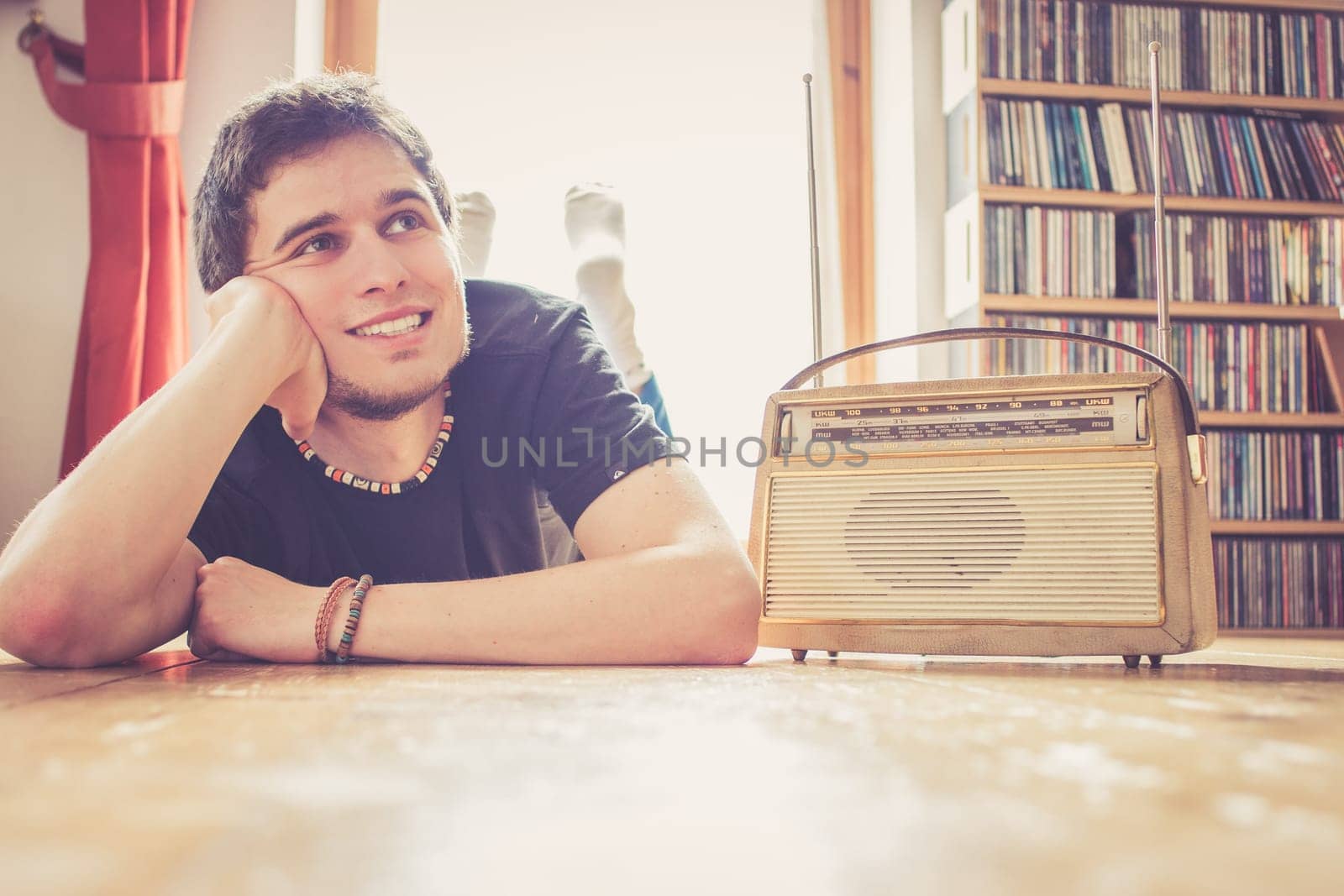Young man listeining to an retro radio