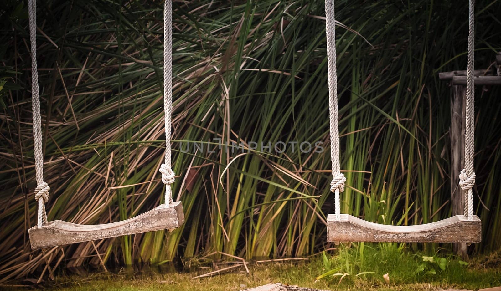 Empty swing on children playground, Children swing in the park, wooden swing, wooden