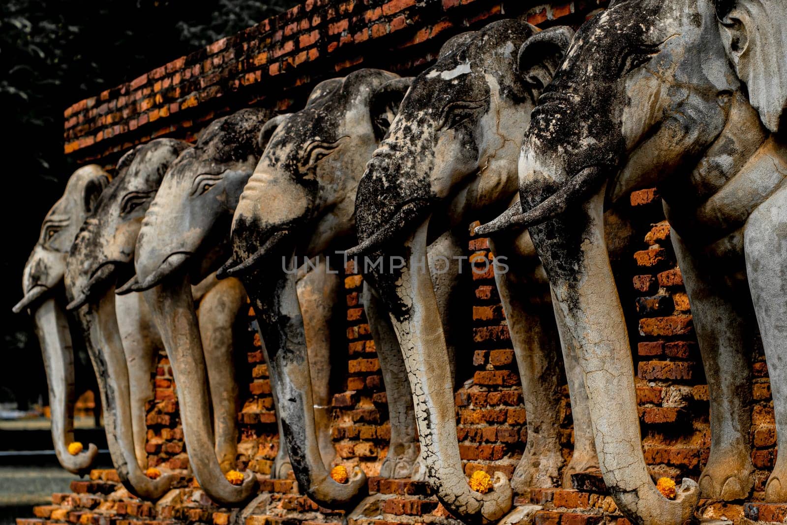 Wat Sorasak chedi surrounded by elephants. CHEDI WAT CHANG LOM (Elephant Temple).Sukhothai Historical Park covers the ruins of Sukhothai. Stupa decorated with elephant reliefs in the temple ruins
