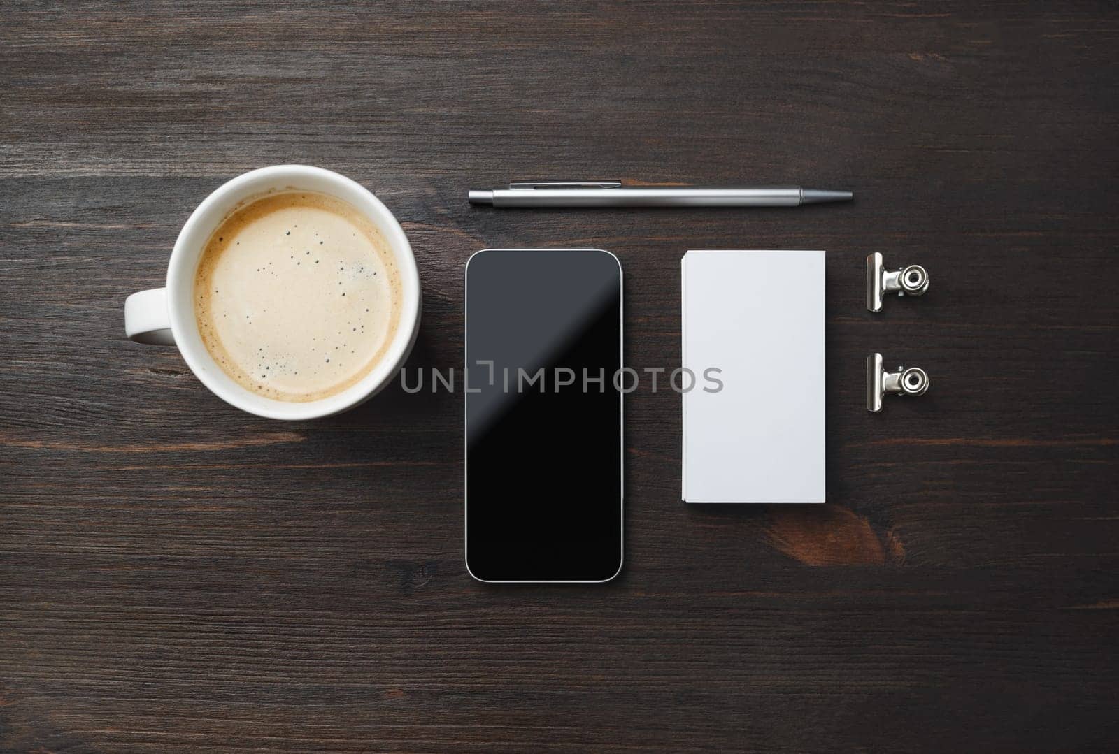 Responsive design template. Coffee cup, smartphone, blank business card and pen on wood table background. Flat lay.