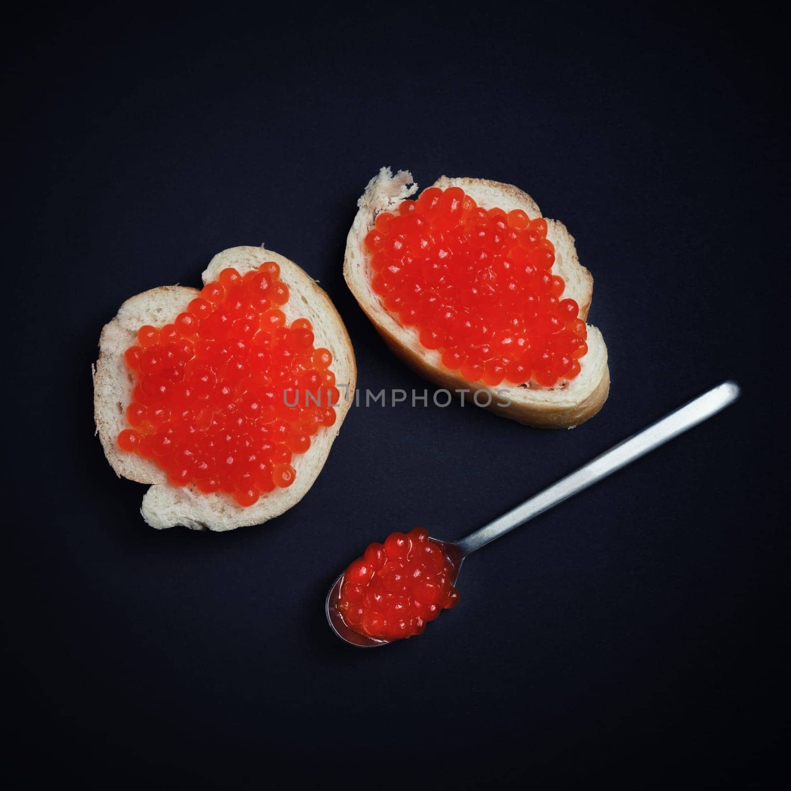 Still life with red caviar, sandwiches and spoon. Flat lay.