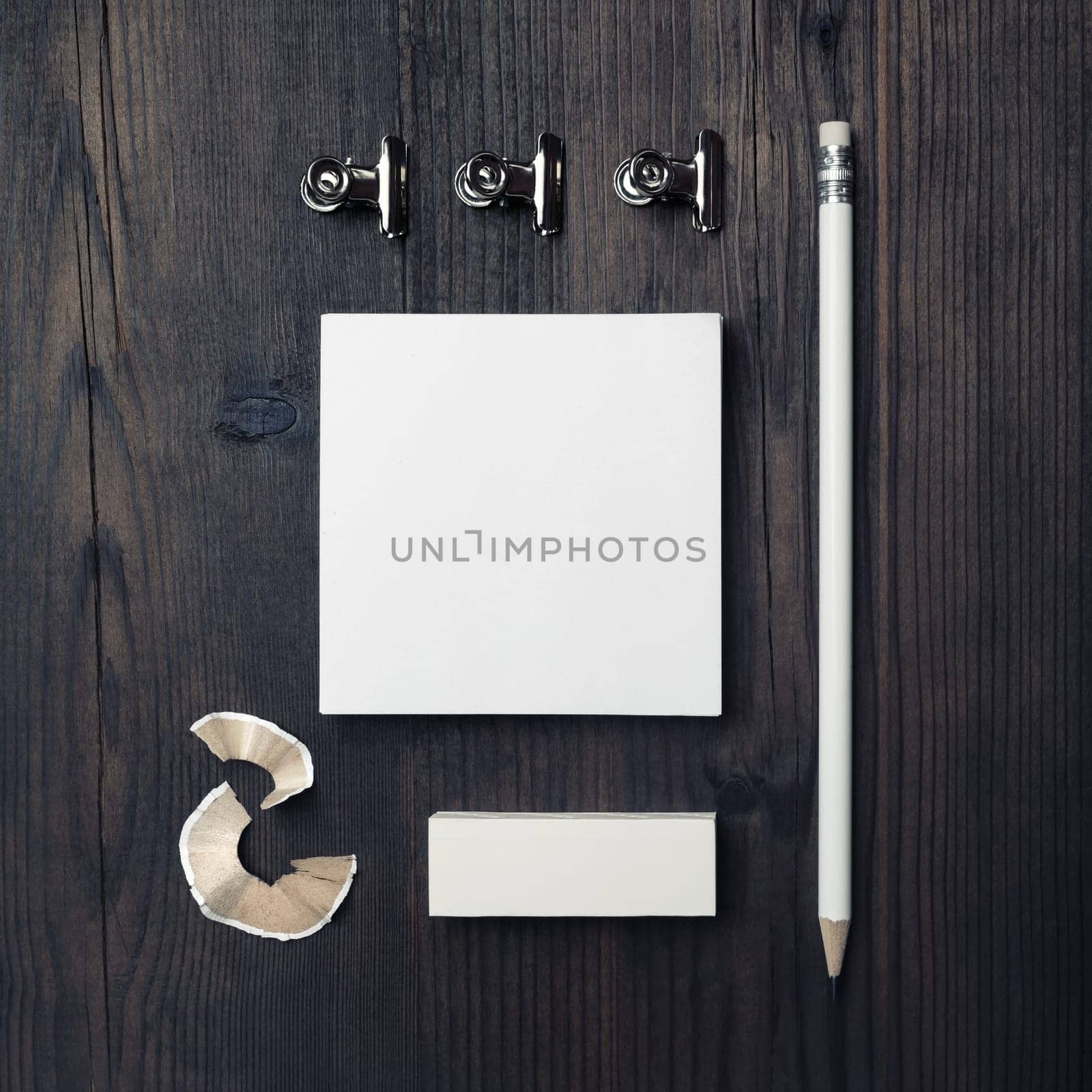Blank stationery template for placing your design. Blank notes, pencil and eraser on wooden background. Mockup for branding identity. Top view. Flat lay.