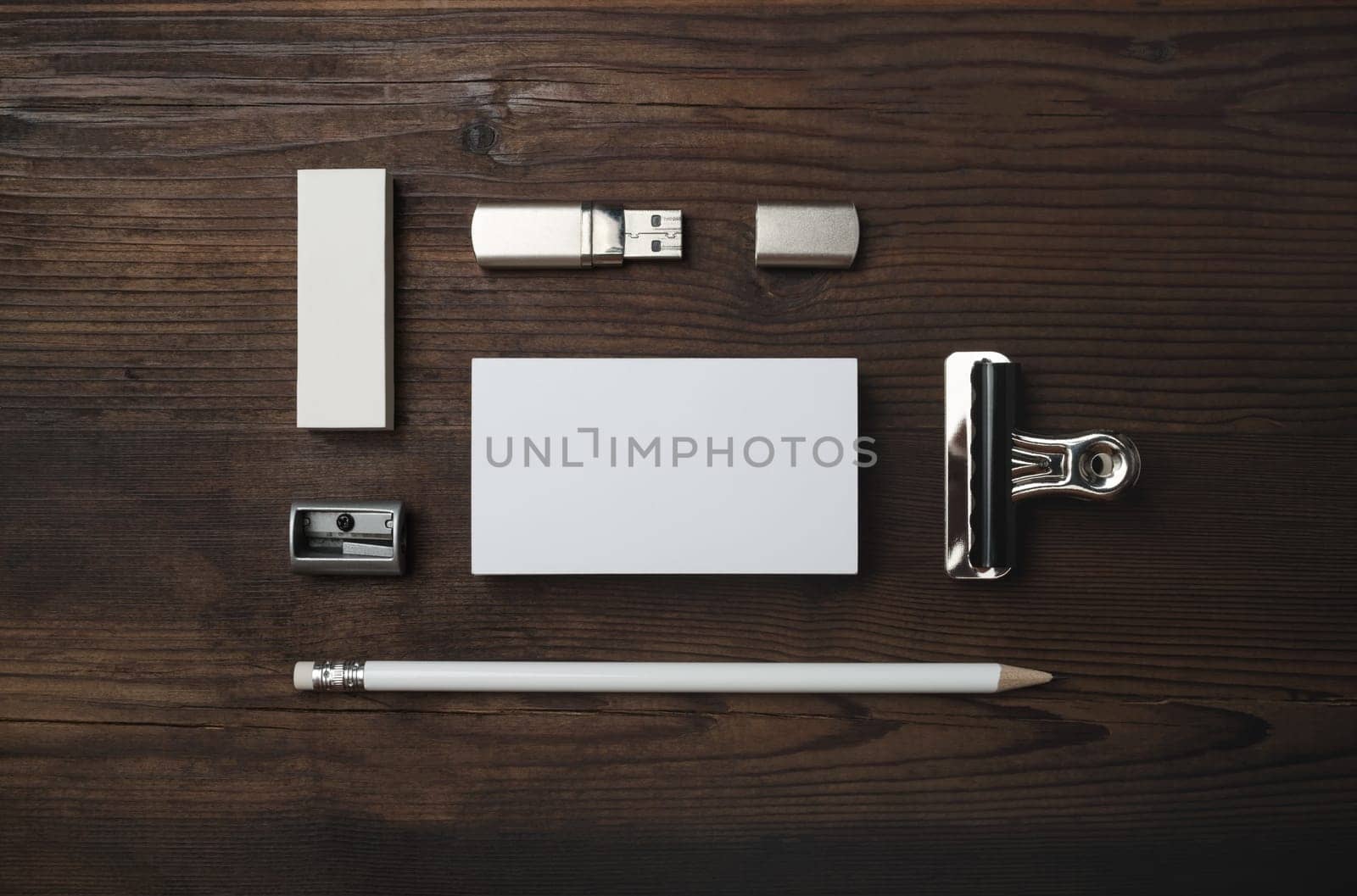 Branding mock up. Blank business card, flash drive, pencil, eraser and sharpener on wood table background. Flat lay.
