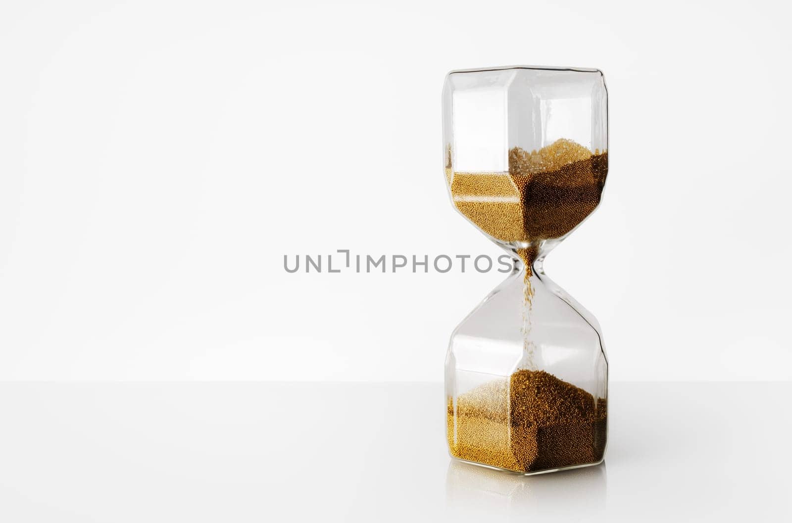 Hourglass on light background with copy space. Time Running Out.