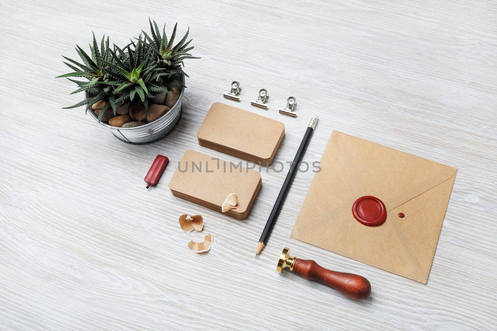 Blank kraft stationery on light wood table background. ID template. Mock-up for branding identity for designers.