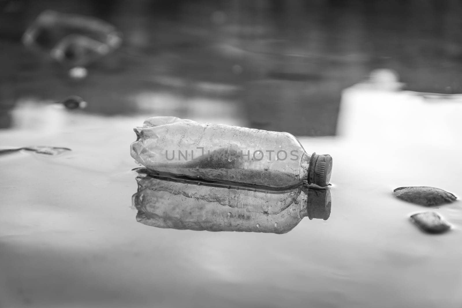 Environmental pollution: plastic bottle on the beach