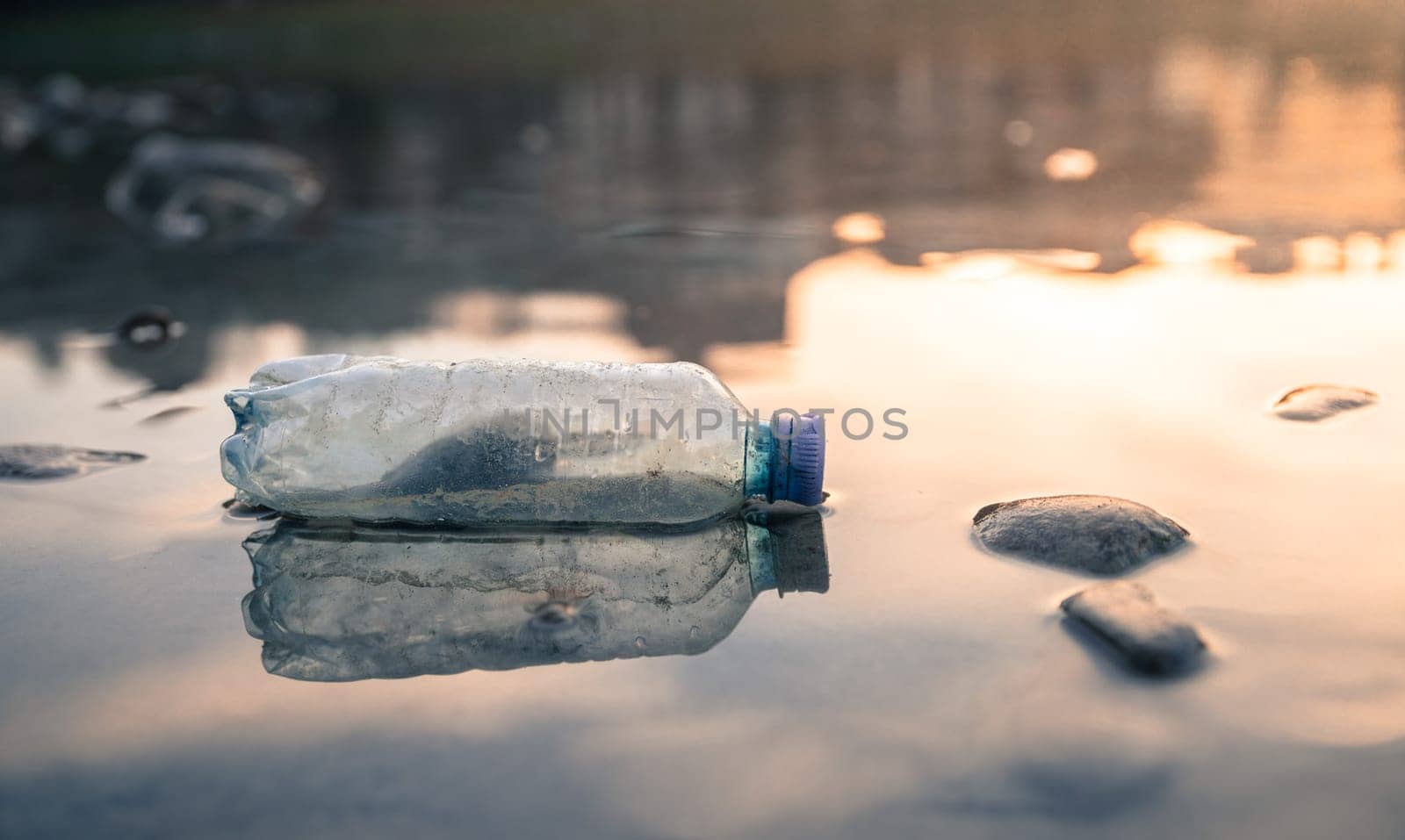 Environmental pollution: plastic bottle on the beach