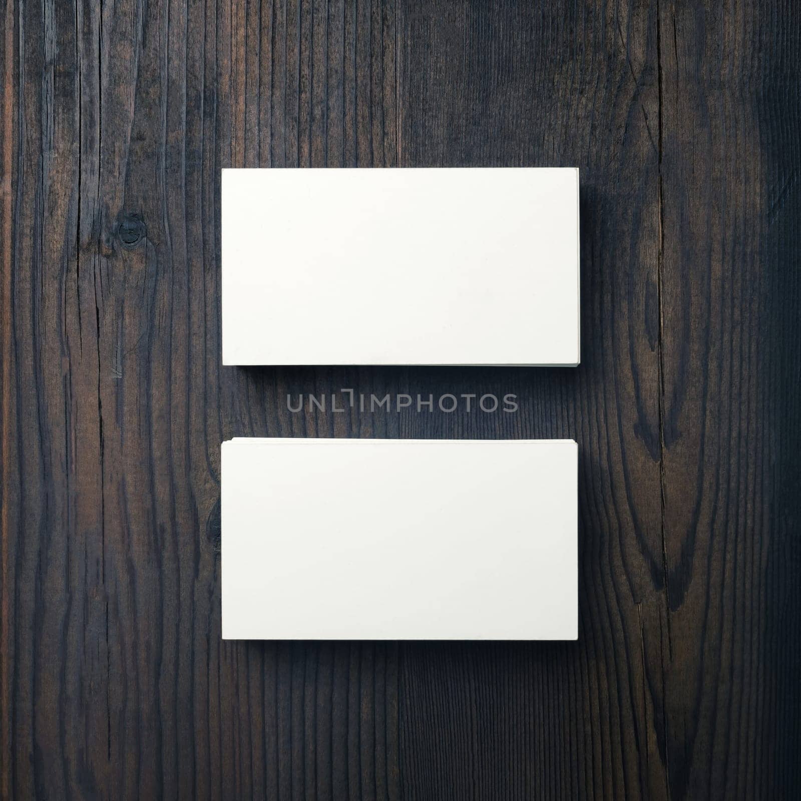 Mockup of blank business cards on wood table background. Top view. Flat lay.