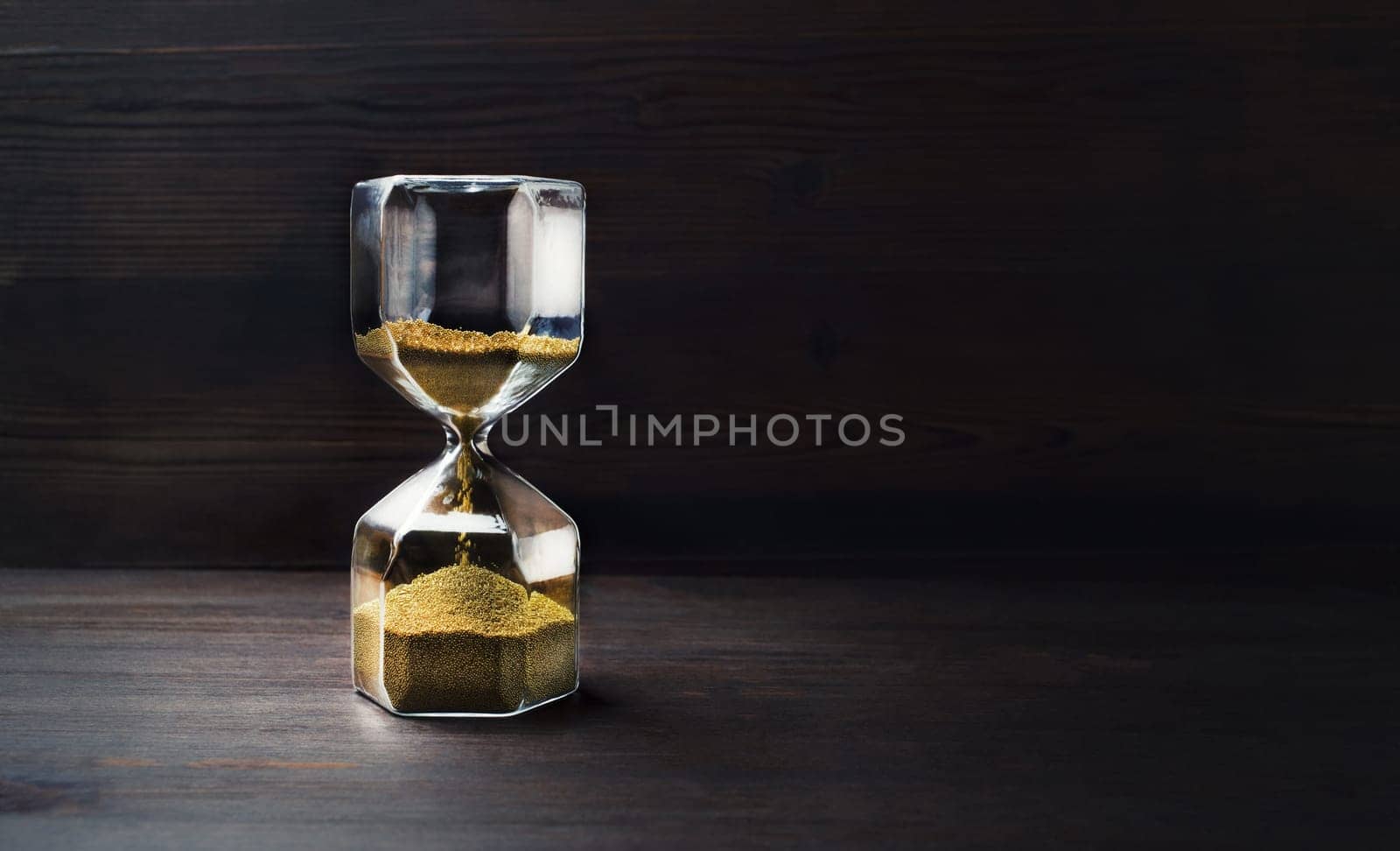 Hourglass on wooden background with copy space. Time Running Out.