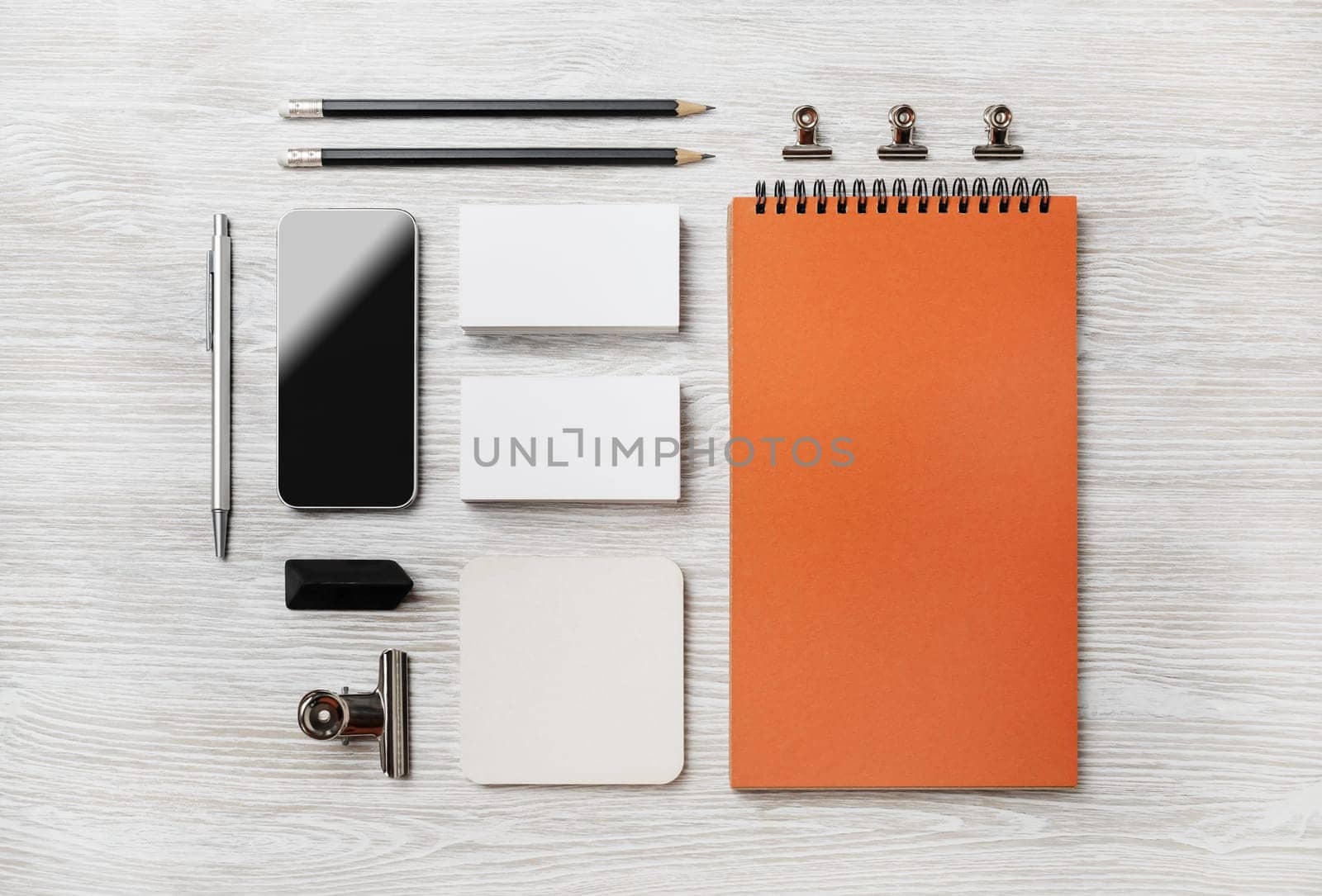 Photo of blank stationery set on light wood table background. Corporate identity template. Responsive design mockup. Top view. Flat lay.