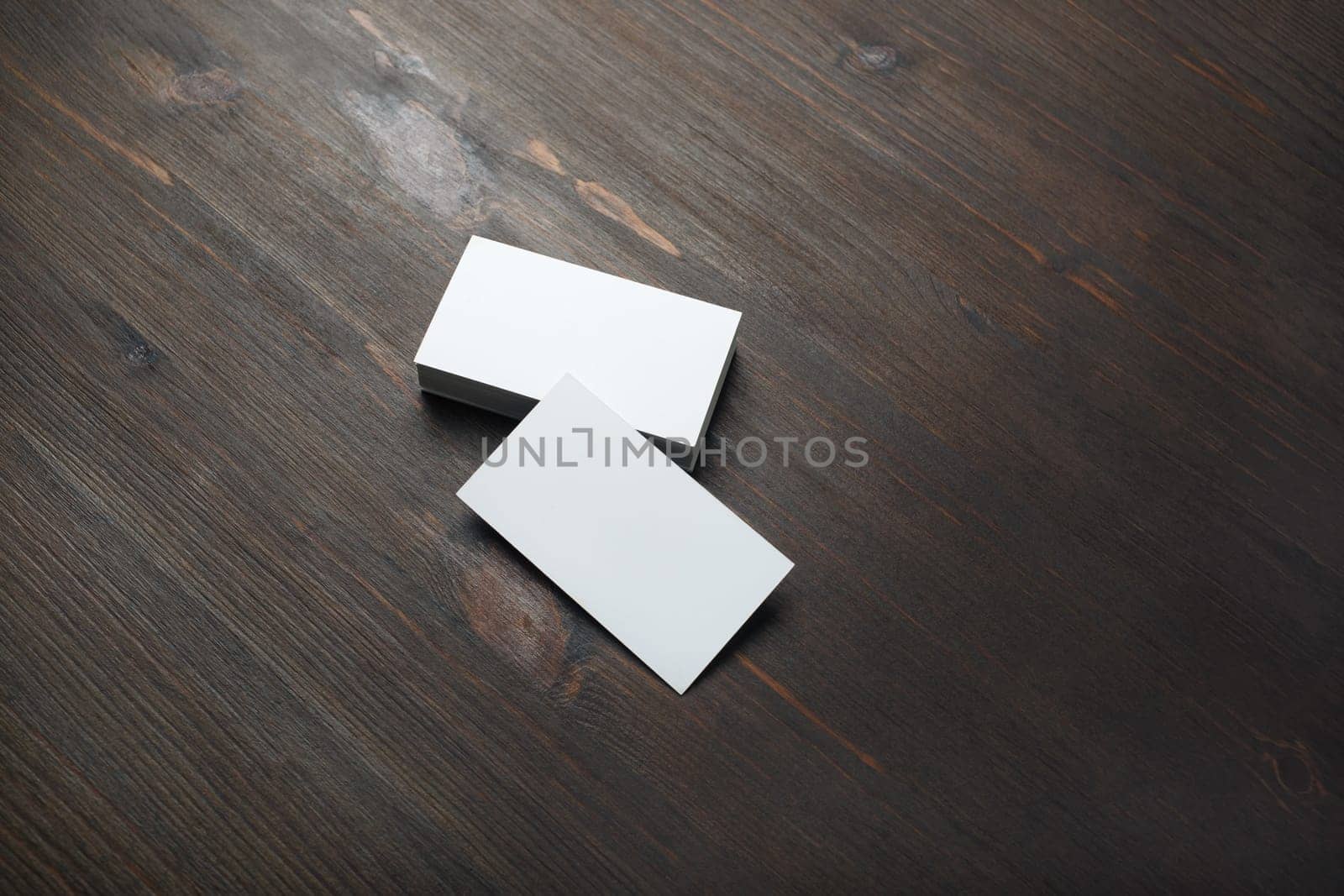 Blank business cards on wood table background. Branding mockup.