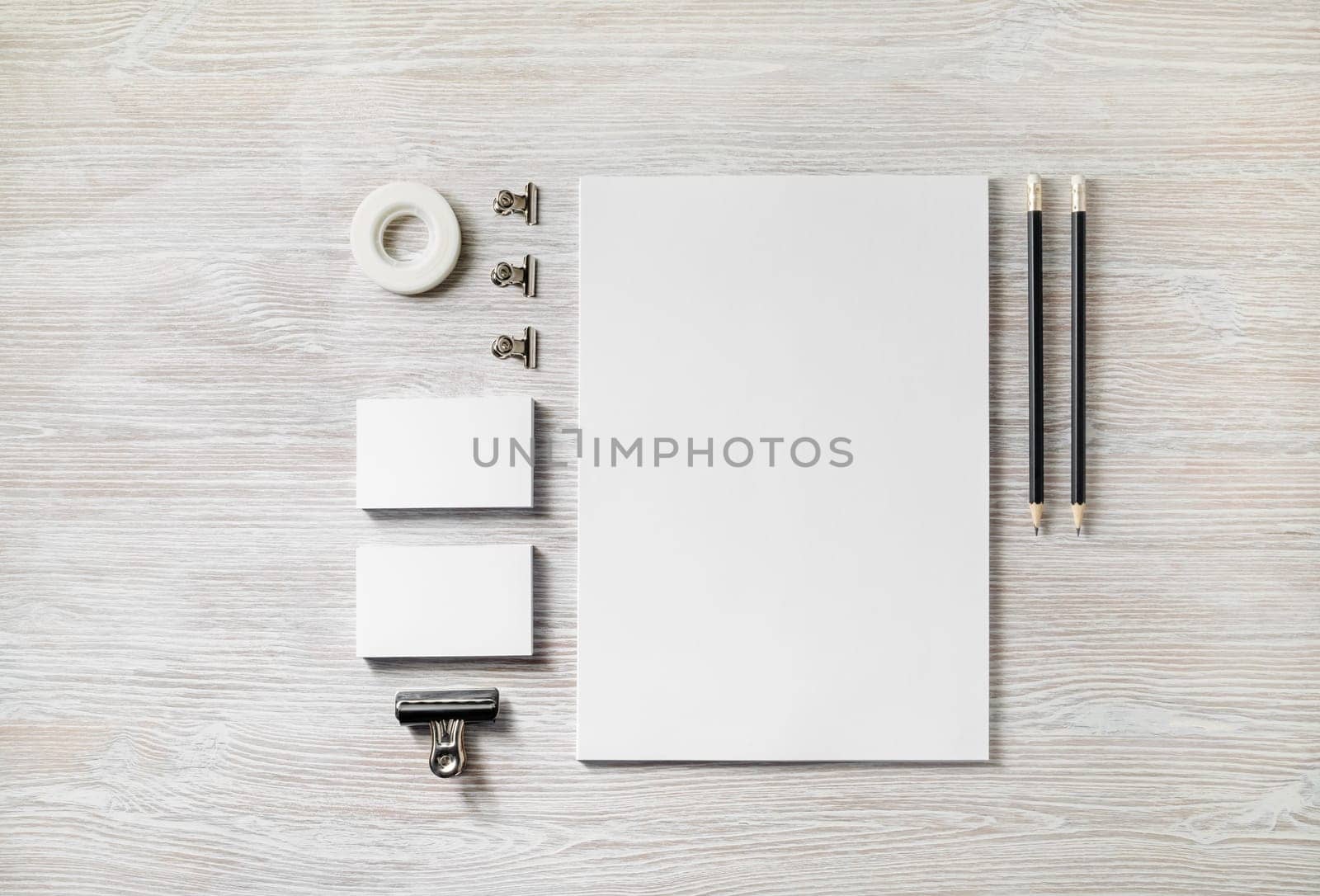 Blank corporate stationery template on light wood table background. Mockup for design presentations and portfolios. Flat lay.