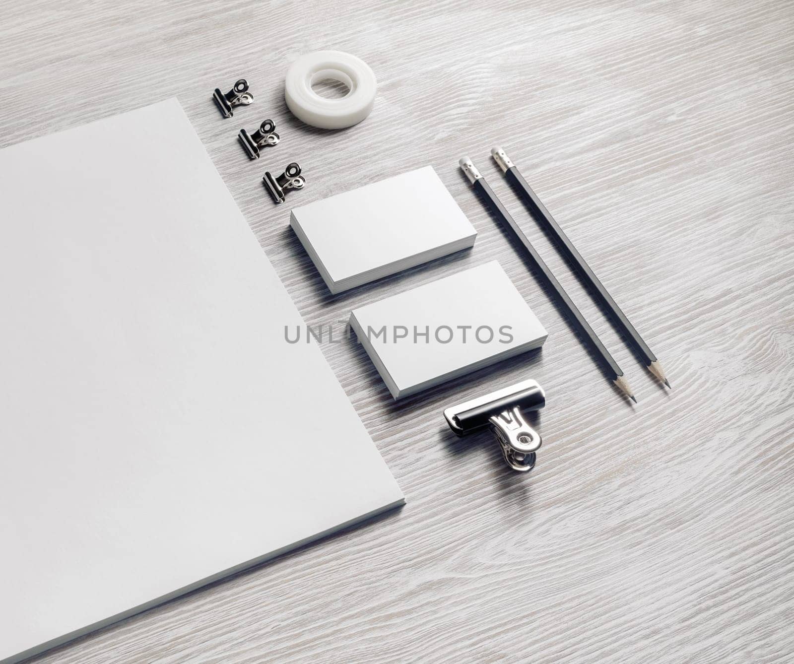 Brand identity mockup. Blank corporate stationery set on light wood table background.
