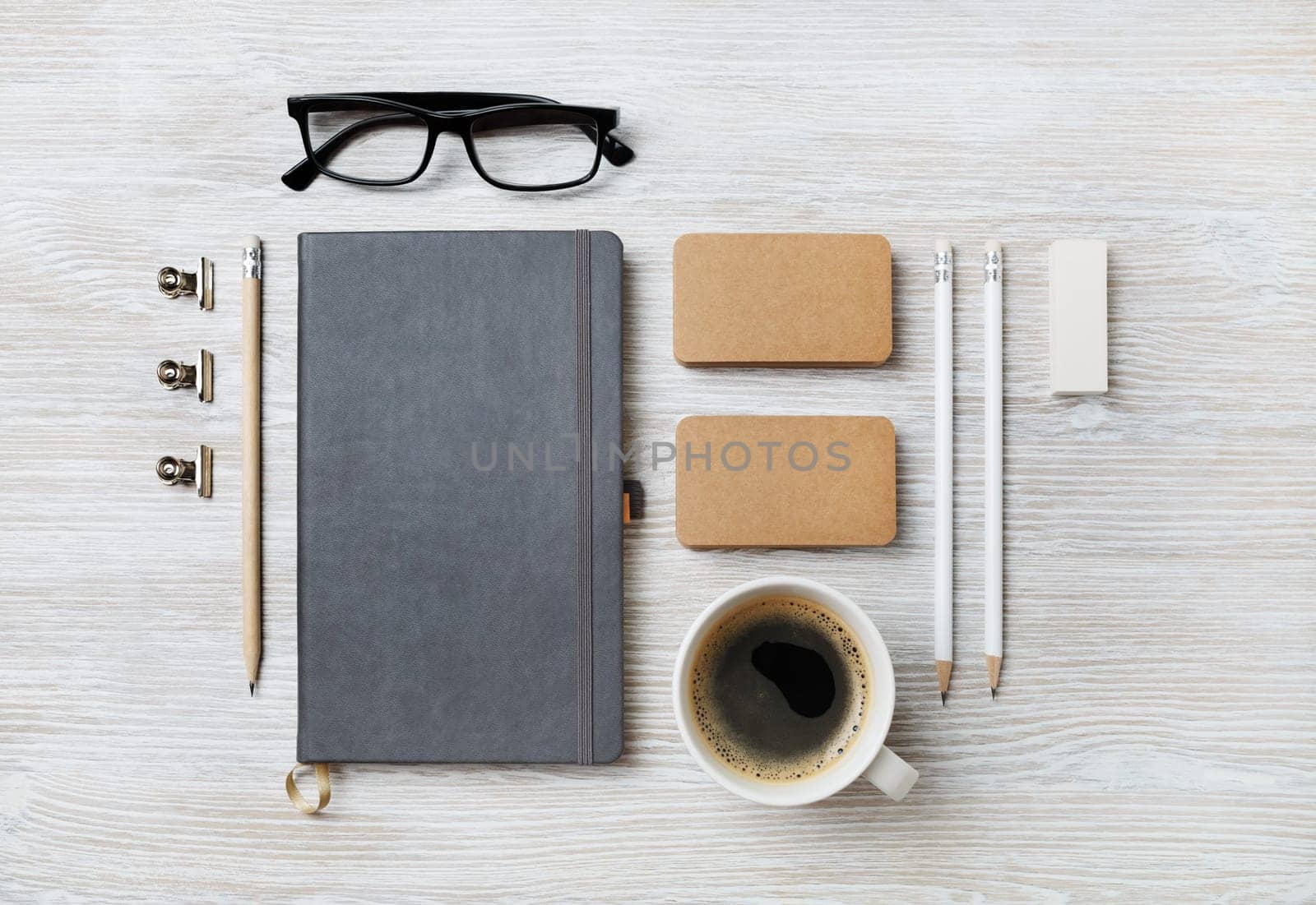 Photo of blank stationery set on light wooden background. Corporate identity mockup. Responsive design template. Top view. Flat lay.