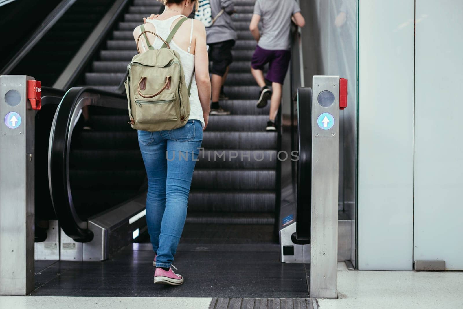 Travelling scene at a train station: young girl and a stairway