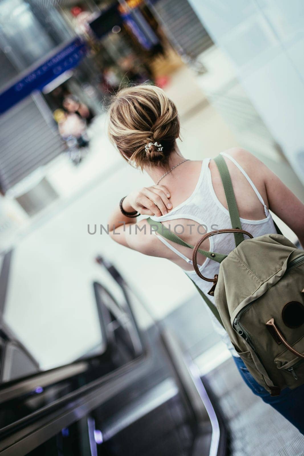 Travelling scene at a train station: young girl and a stairway