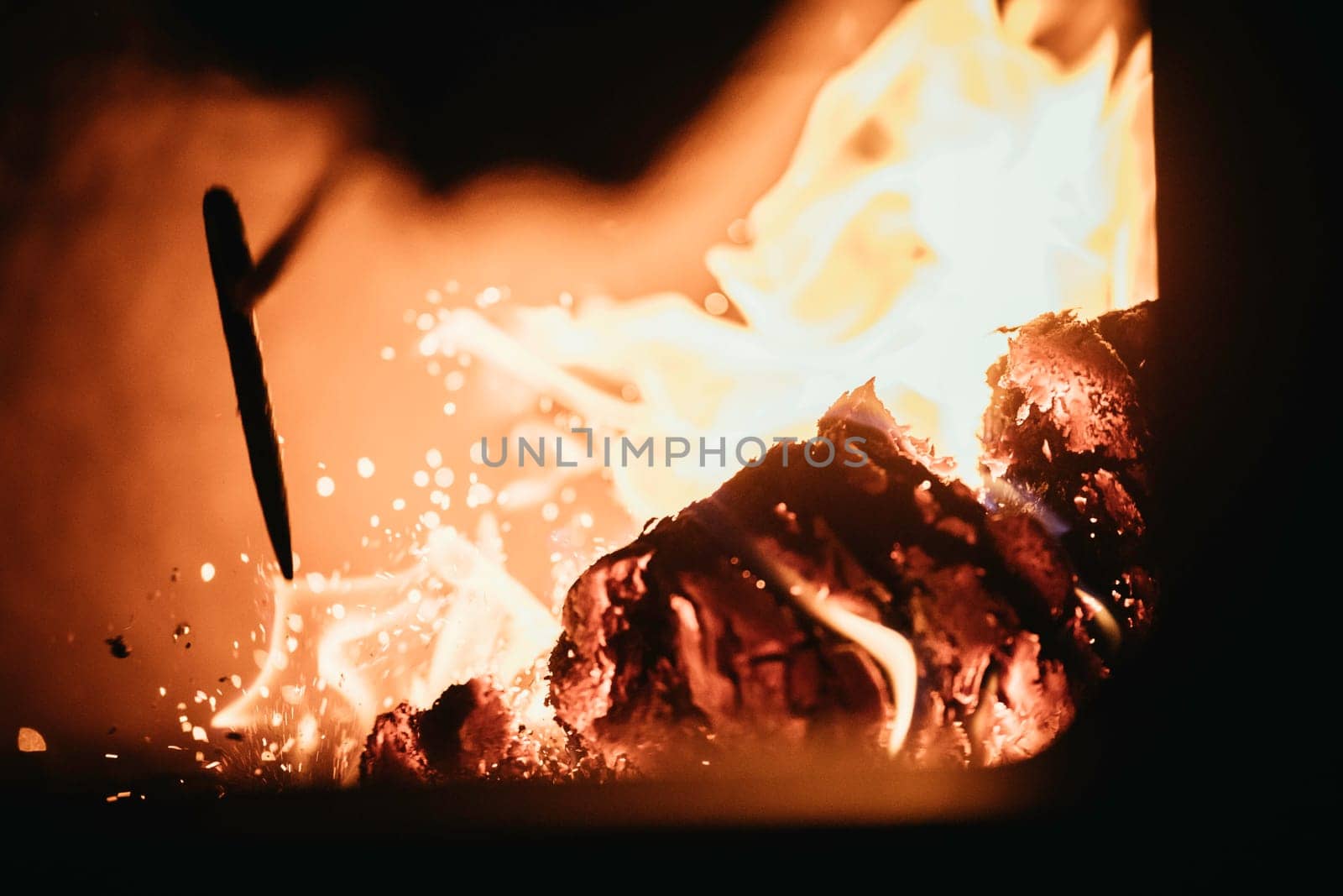 Blaze fire flame in oven, poking stick and sparks