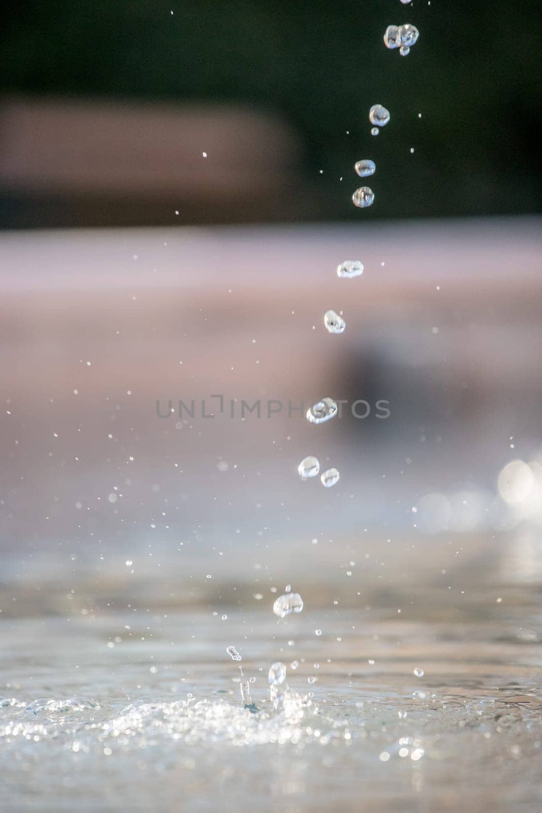Fresh water drops falling into a well, summer time