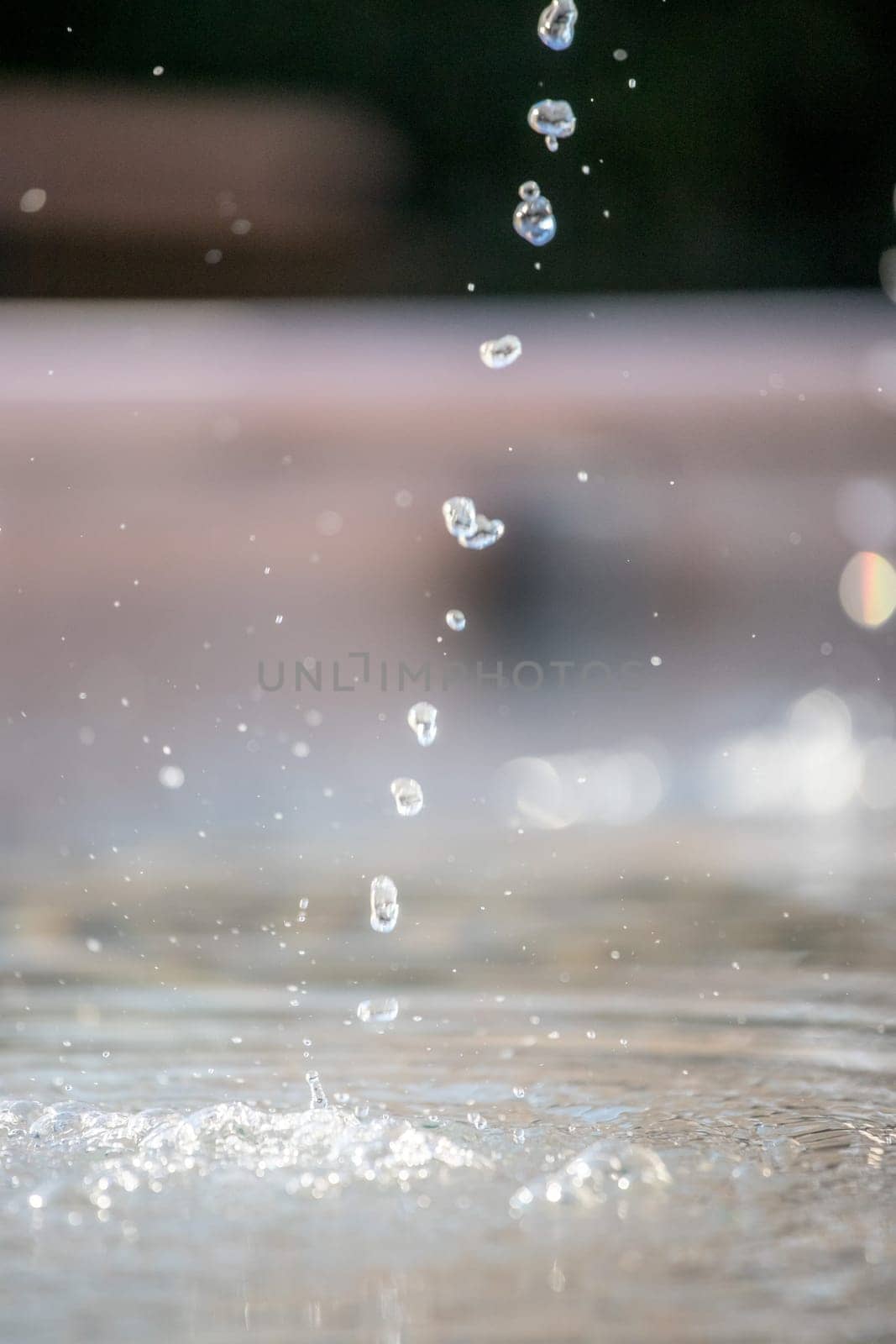 Fresh water drops falling into a well, summer time