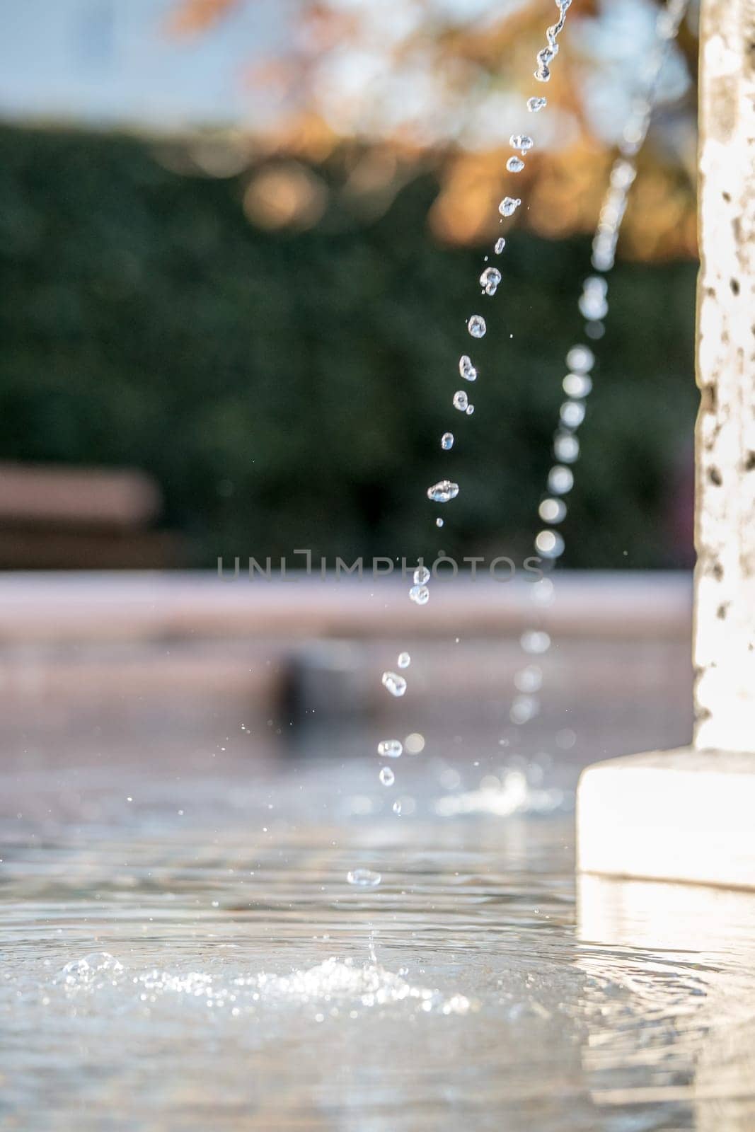 Fresh water drops falling into a well, summer time