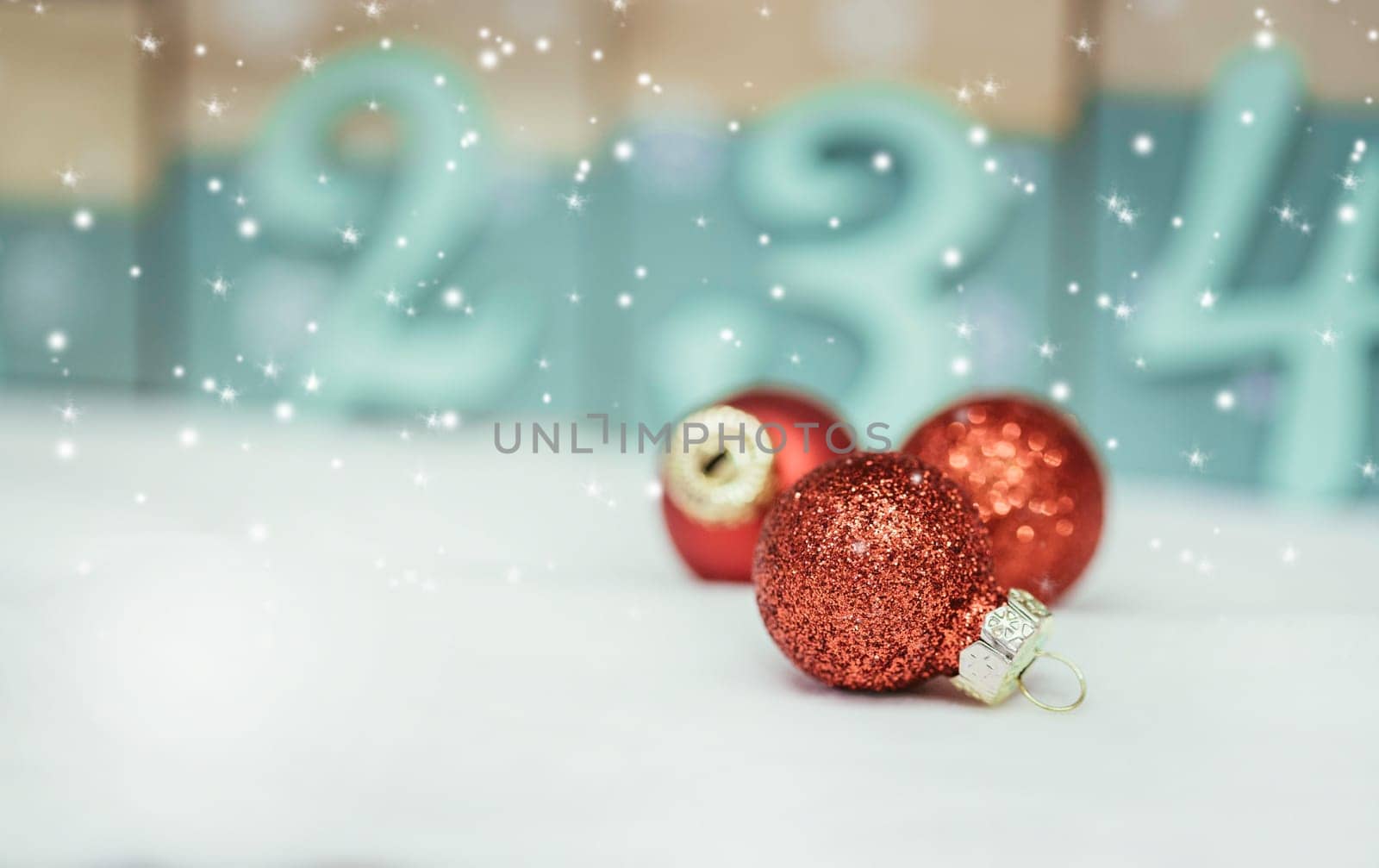 Christmas decoration: Close up of red Christmas baubles, advent calendar in the blurry background