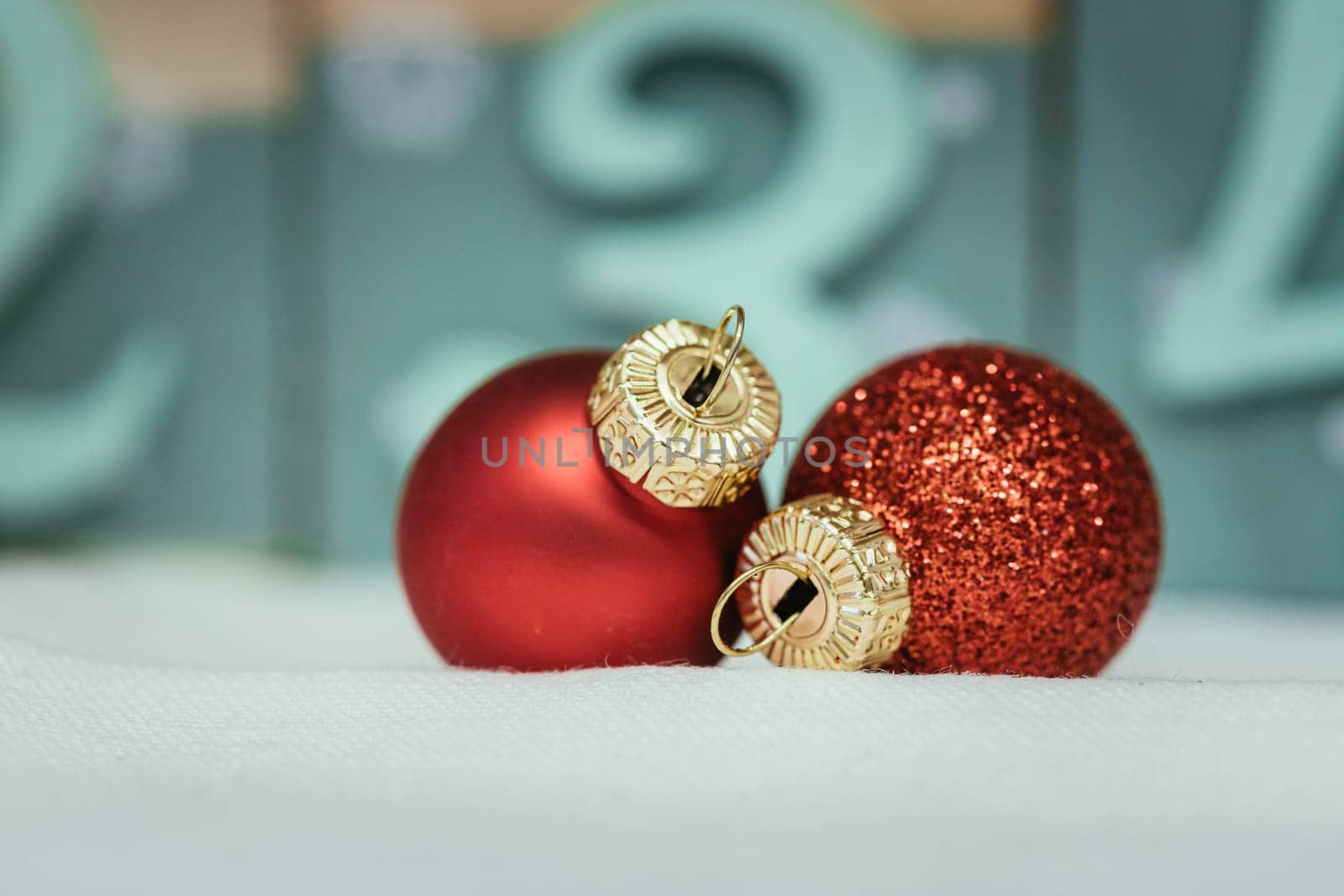 Christmas decoration: Close up of red Christmas baubles, advent calendar in the blurry background