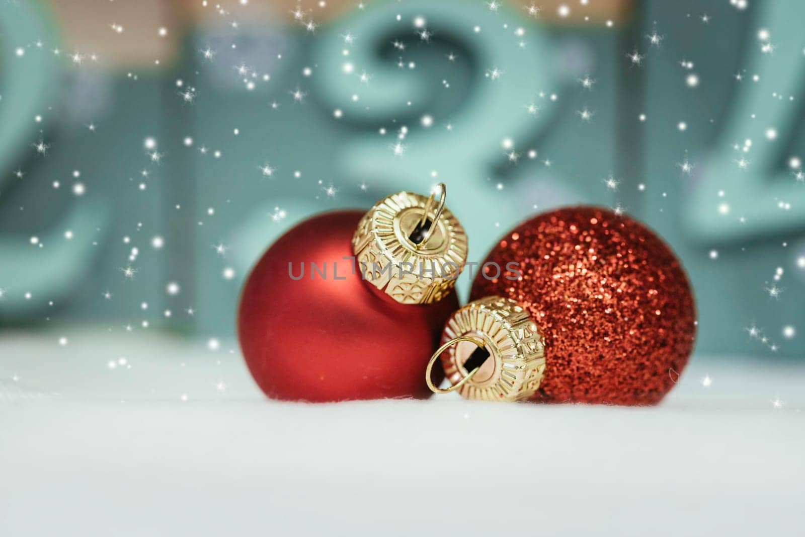 Christmas decoration: Close up of red Christmas baubles, advent calendar in the blurry background
