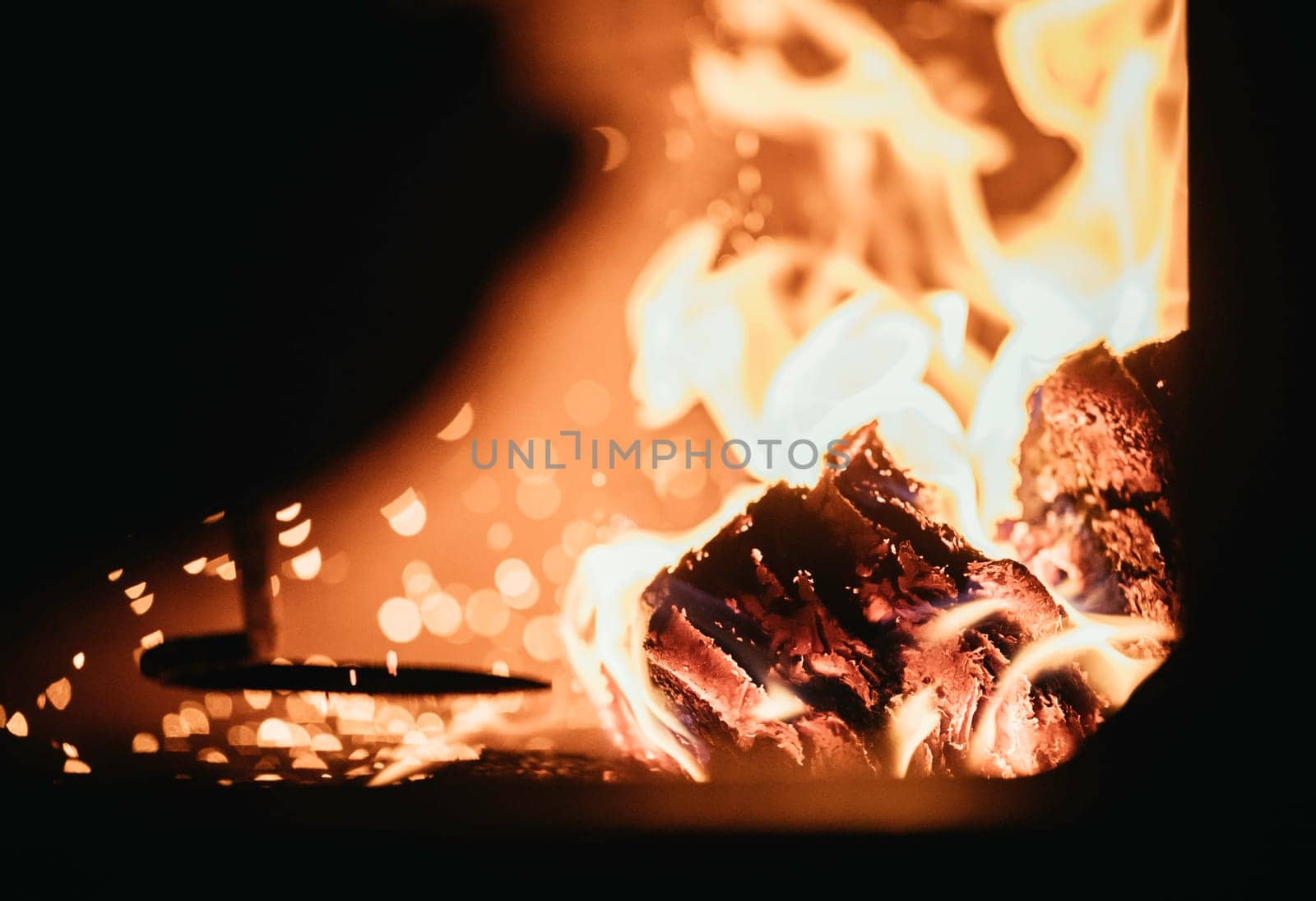 Blaze fire flame in oven, poking stick and sparks