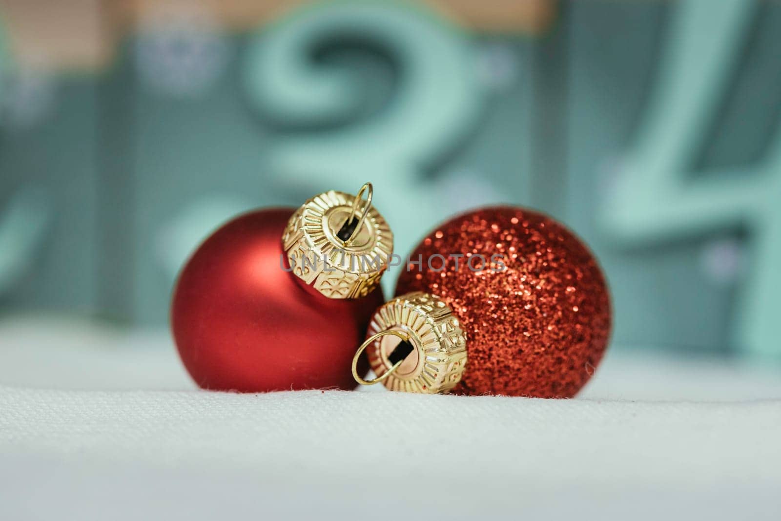 Christmas decoration: Close up of red Christmas baubles, advent calendar in the blurry background