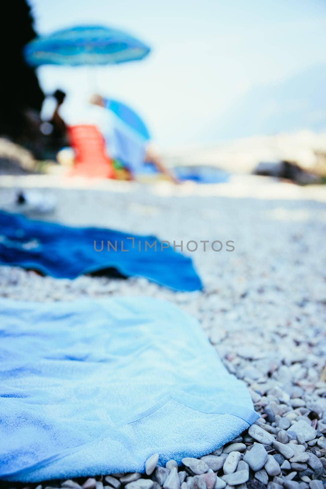 Bathing towel on the beach  other people in blurry background