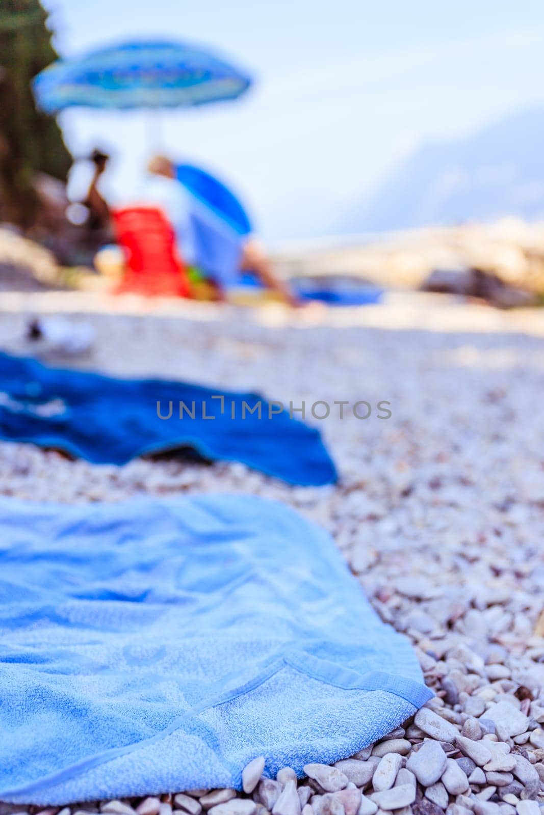 Bathing towel on the beach  other people in blurry background