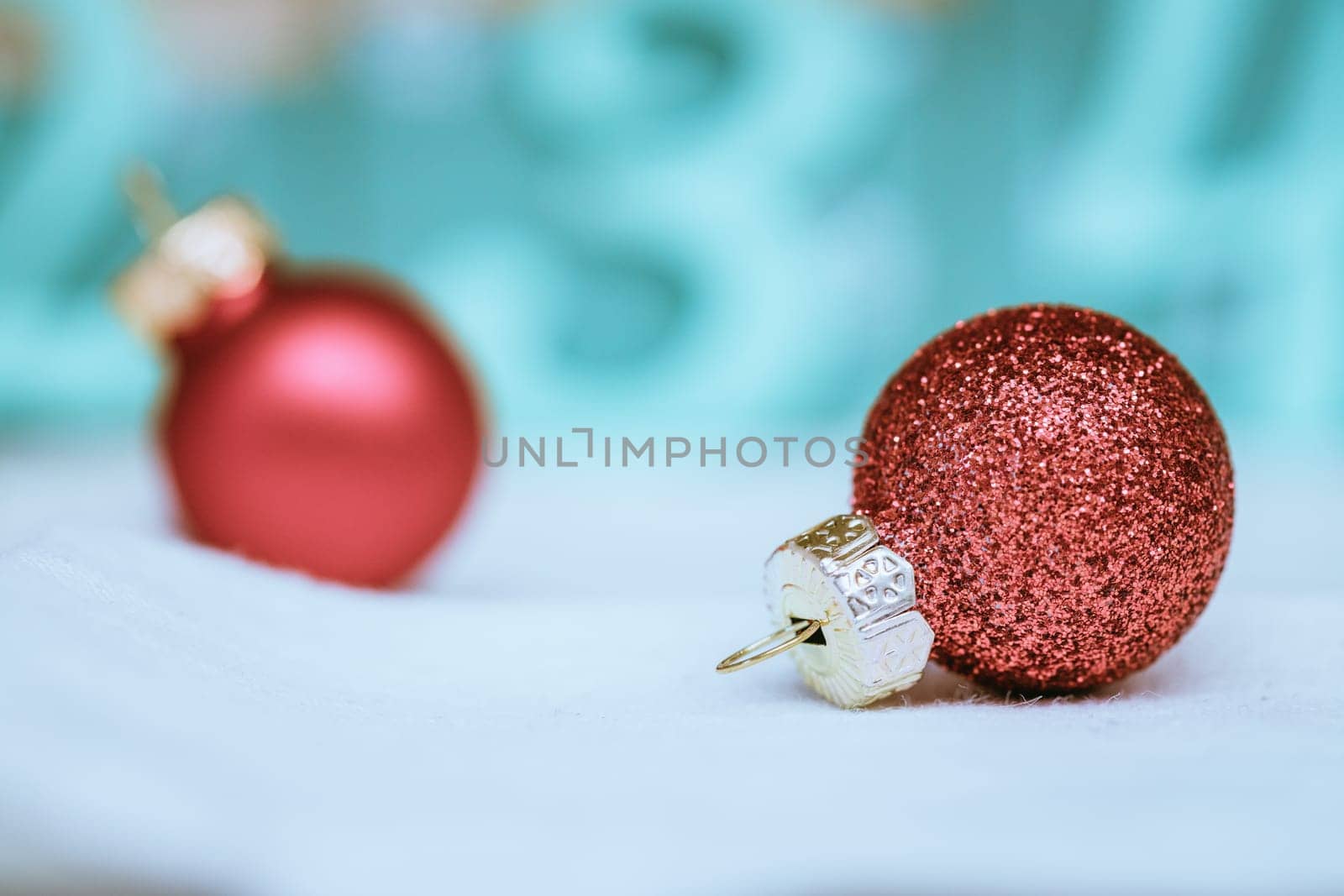 Christmas decoration: Close up of red Christmas baubles, advent calendar in the blurry background