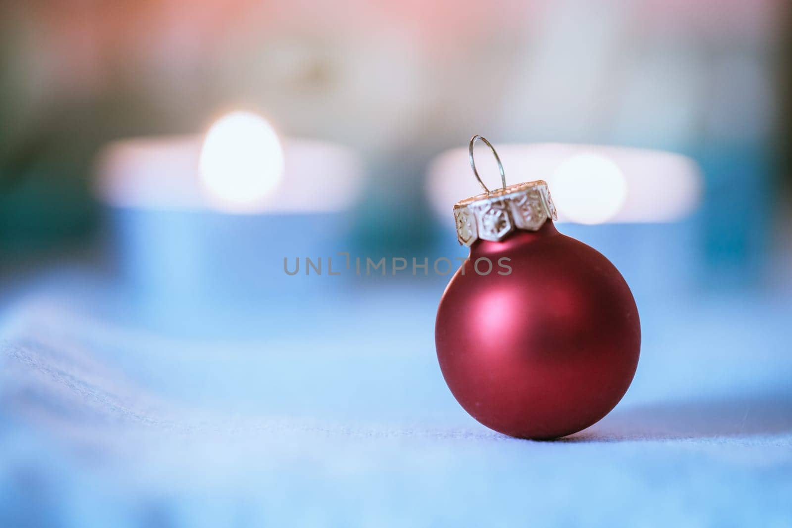 Christmas decoration: Close up of red Christmas baubles, advent calendar in the blurry background